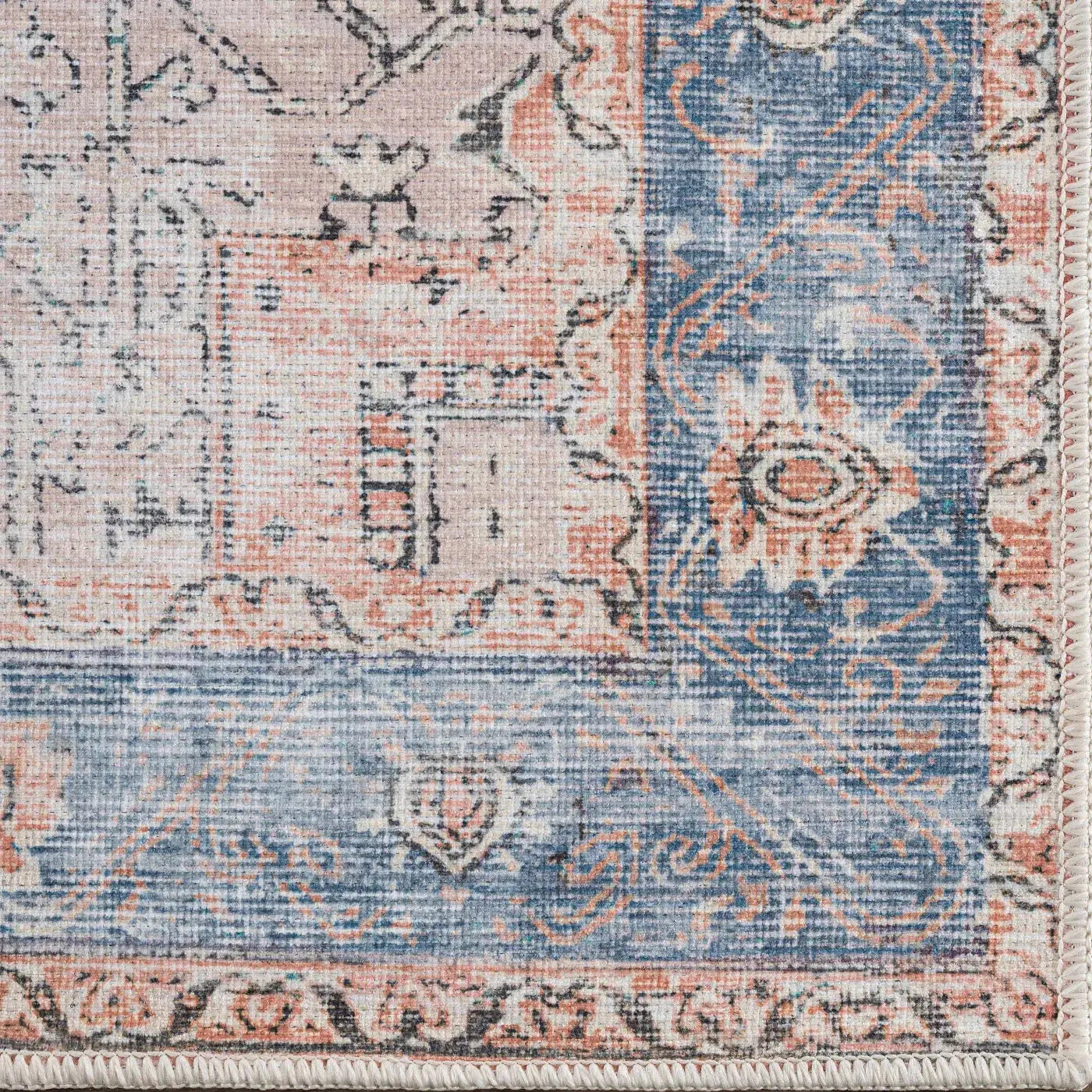 Vintage-style area rug with blue and coral floral patterns, perfect for cozy farmhouse decor