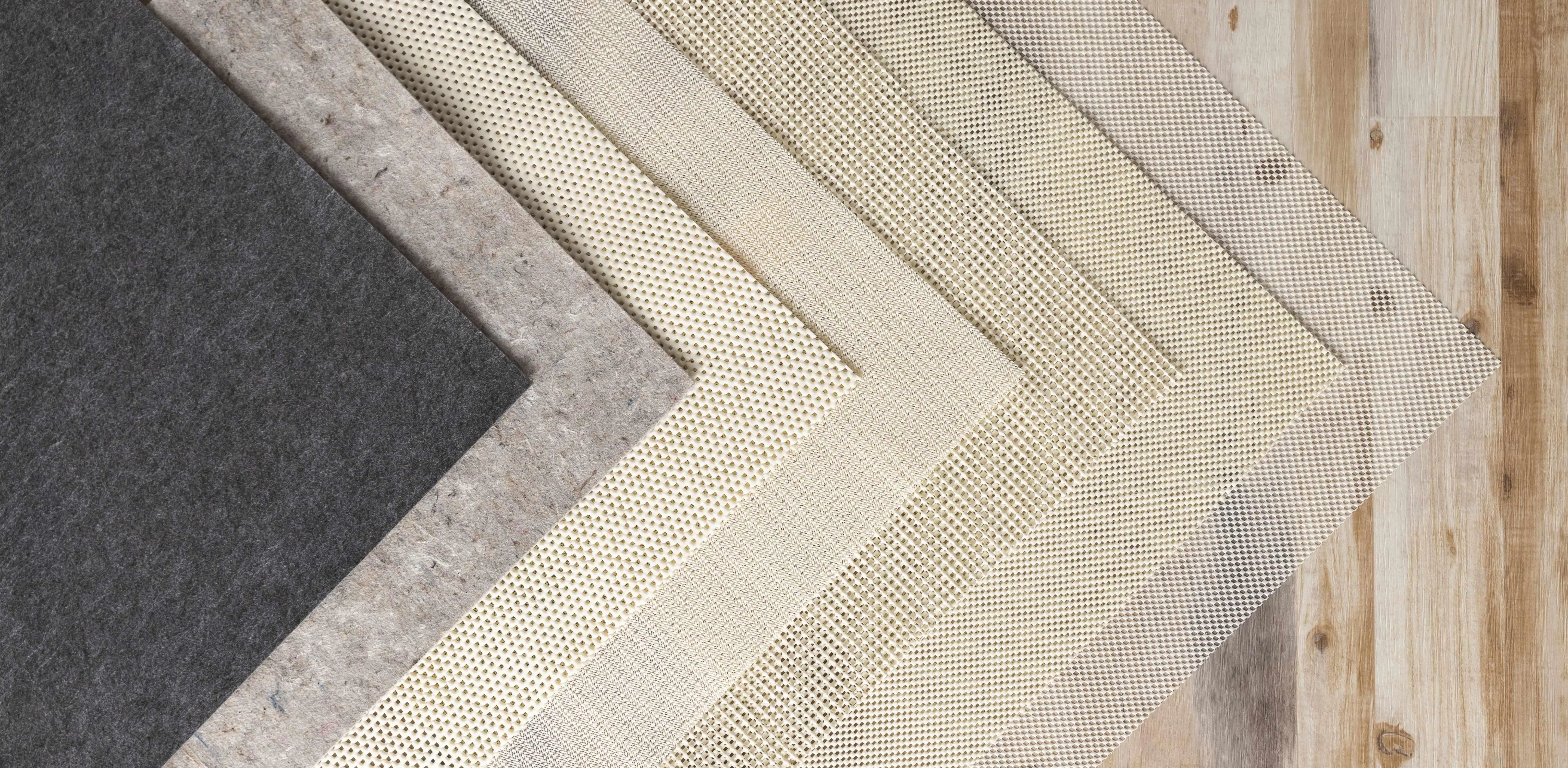 Cozy farmhouse-style placemats in neutral tones, featuring woven textures and geometric patterns on a rustic wood surface.