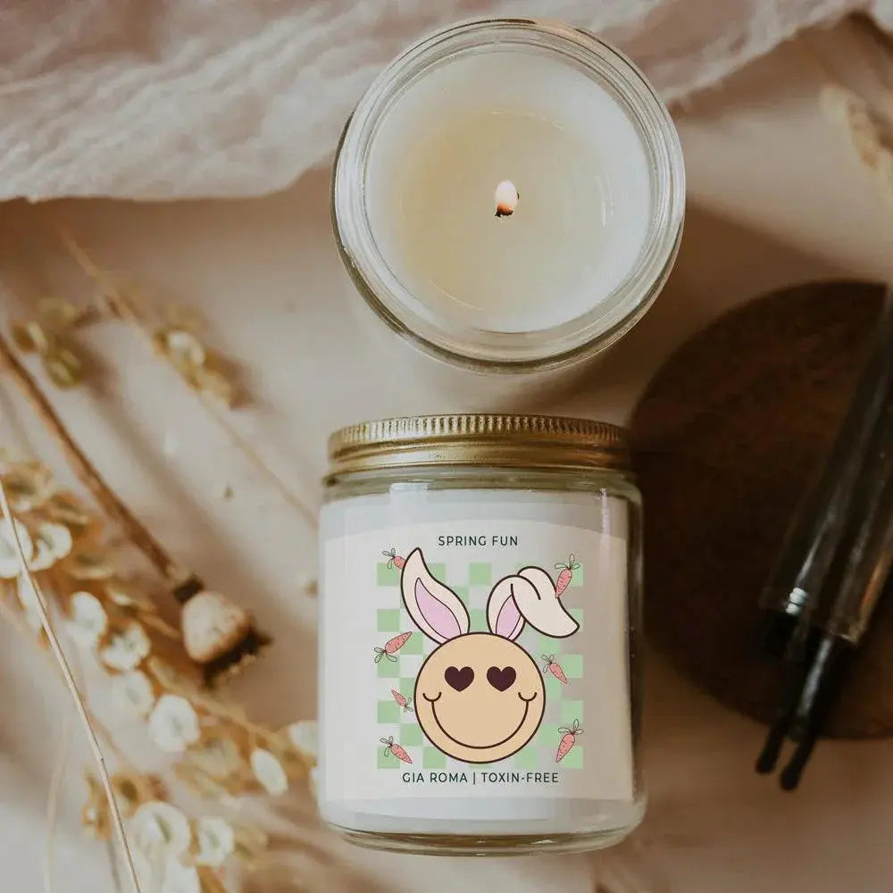 Candle in a jar with a decorative label on a textured surface