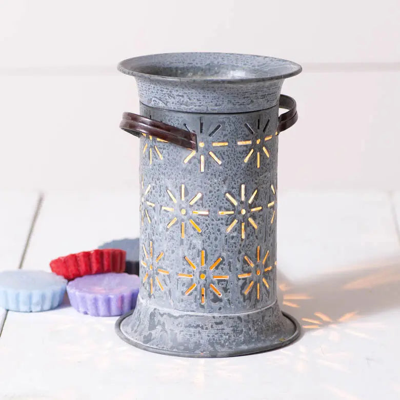 Weathered zinc starburst wax warmer with cutout design and colorful wax melts