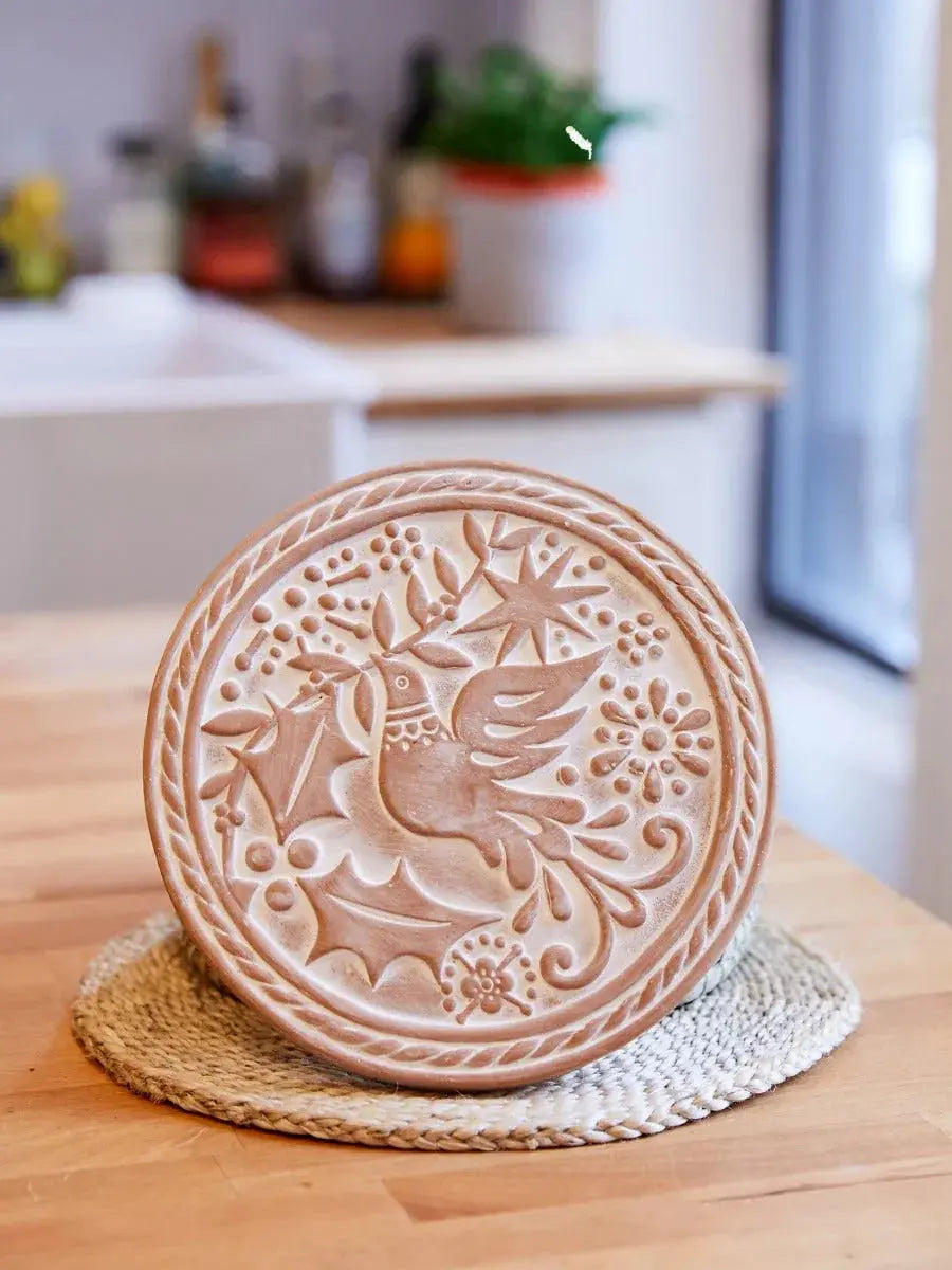 Rustic ceramic wall decor with embossed dove and holly, perfect for cozy farmhouse or cottage style homes