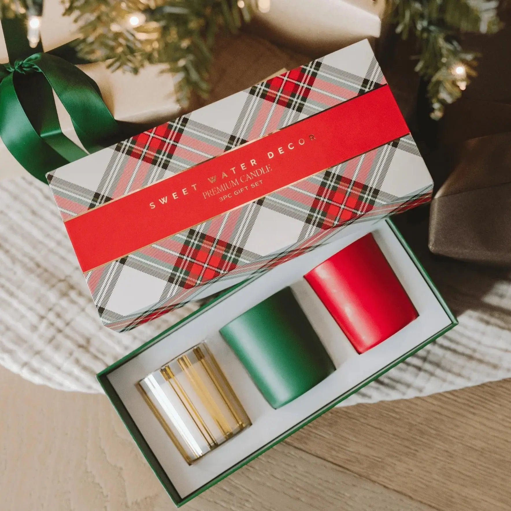 Sweet Water Decor 3-piece premium candle gift set in festive plaid box with red, green, and gold candles, perfect for cozy holiday home decor.