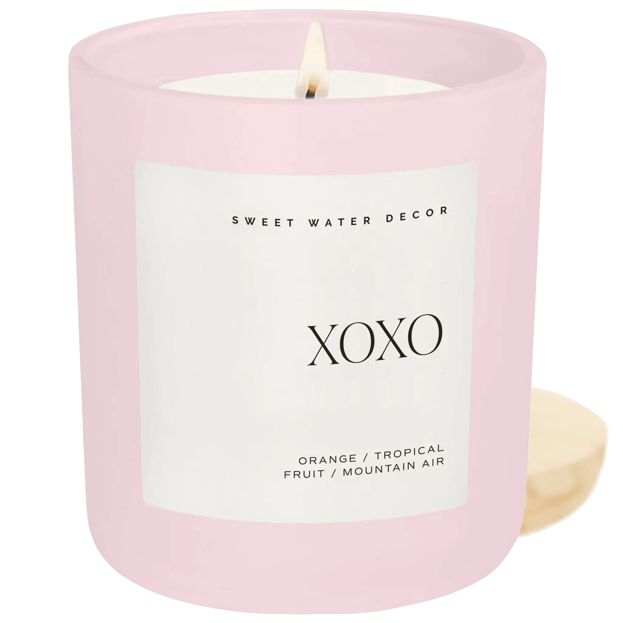 Pink ceramic XOXO candle with orange tropical fruit scent, cozy home decor