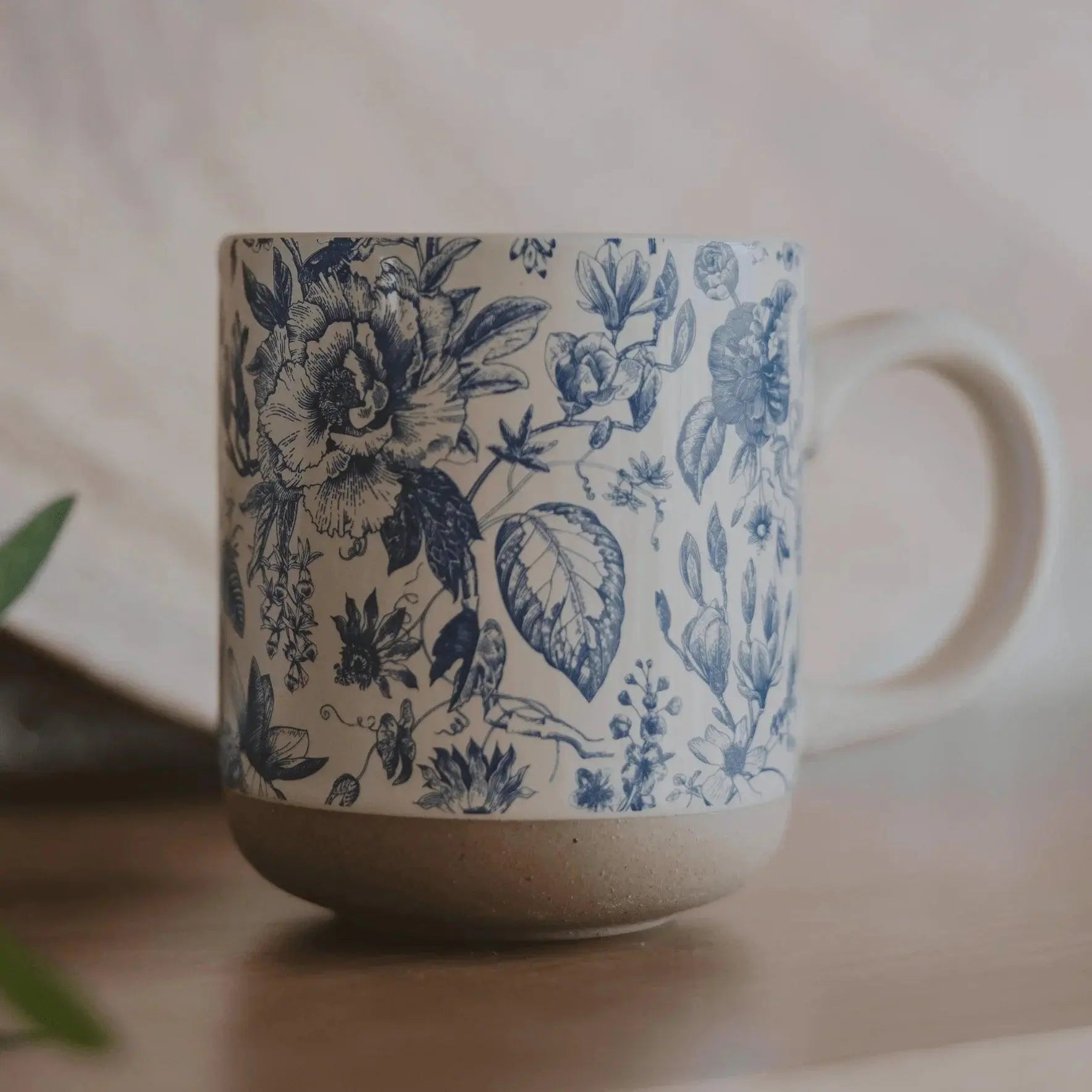 Blue floral patterned ceramic mug with rustic base, perfect for cozy farmhouse decor