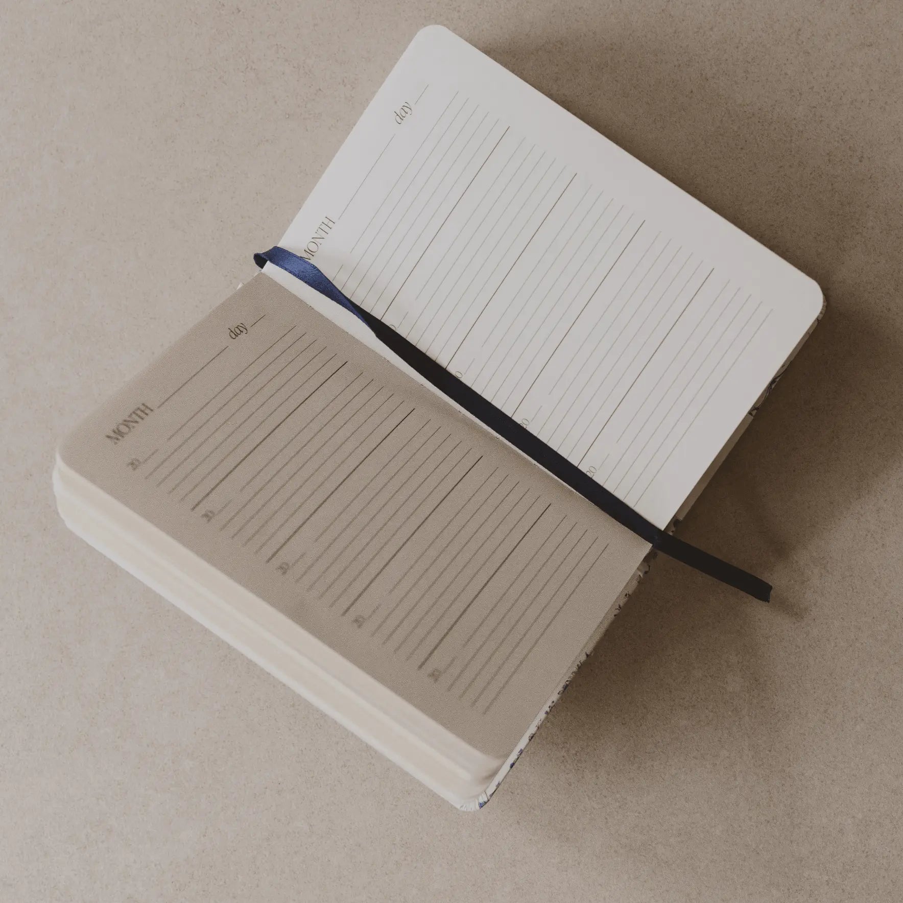 Two notebooks with lined pages on a beige surface