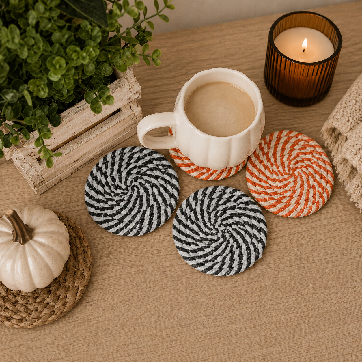 Coasters with a cup of coffee, candle, and decorative items on a wooden surface