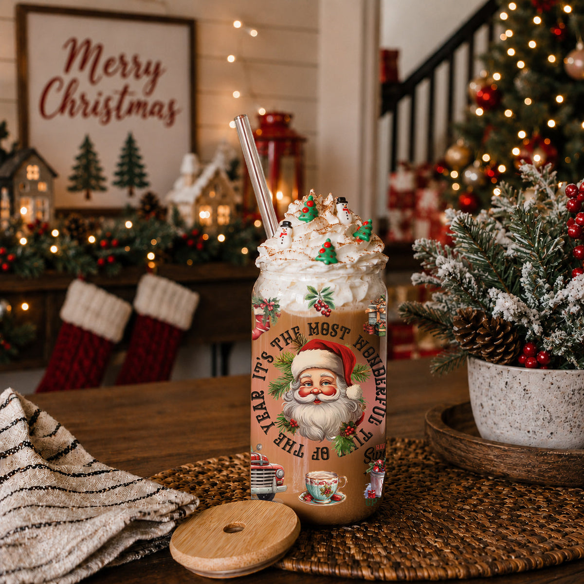 Christmas-themed hot chocolate with whipped cream and a Santa Claus design on a table decorated for the holidays.