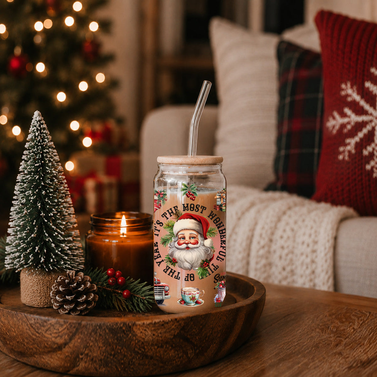 Christmas-themed tumbler with Santa Claus design on a wooden table with festive decorations.