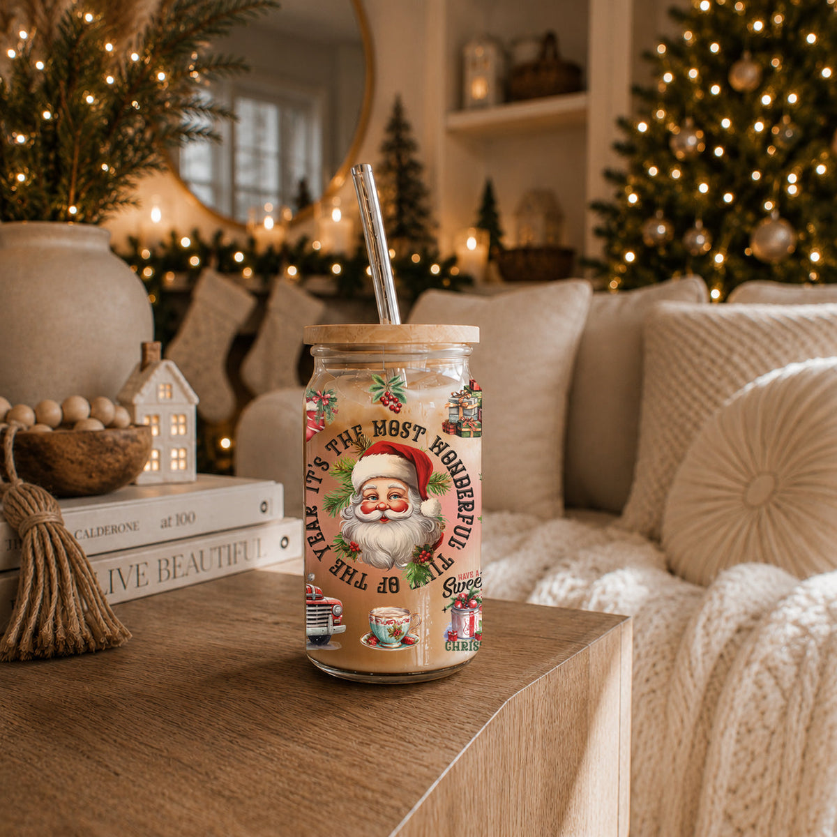 Christmas-themed tumbler with Santa Claus design on a table with festive decorations in the background.