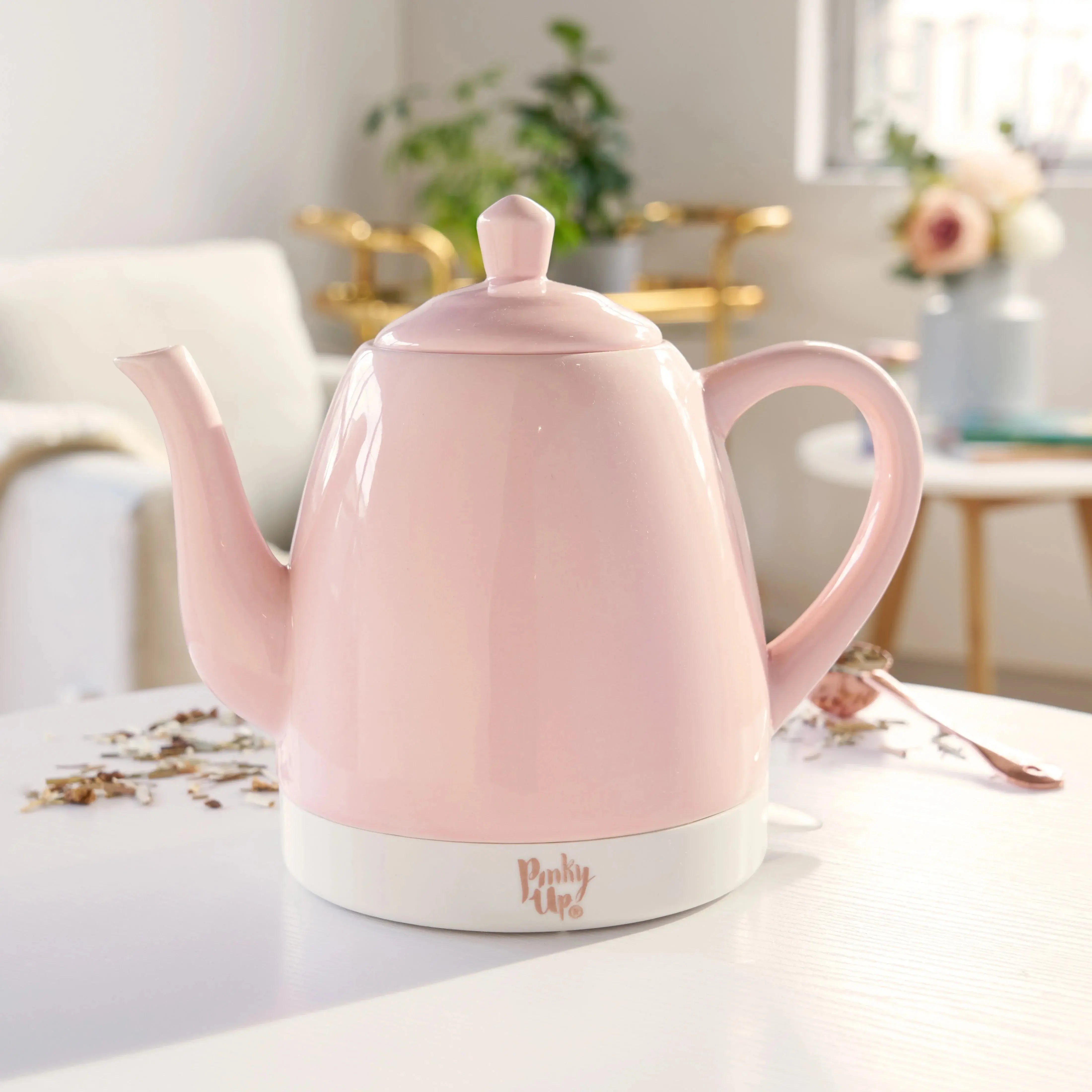 Pink electric kettle on a kitchen counter with a blurred background