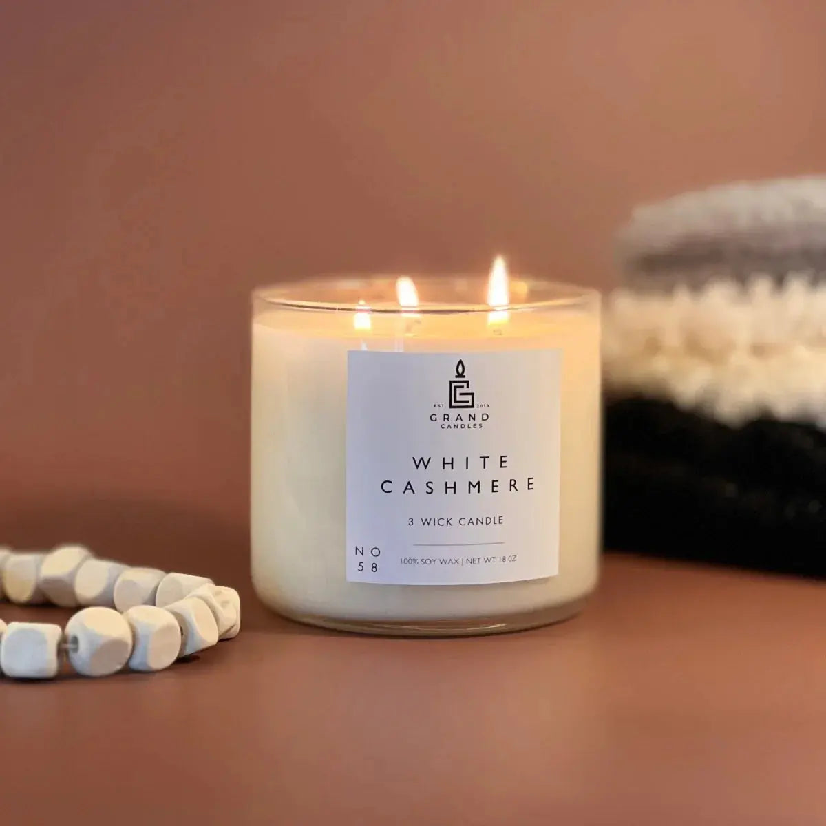 White Cashmere 3-wick soy candle in glass jar, cozy farmhouse decor with wooden beads and knit blanket