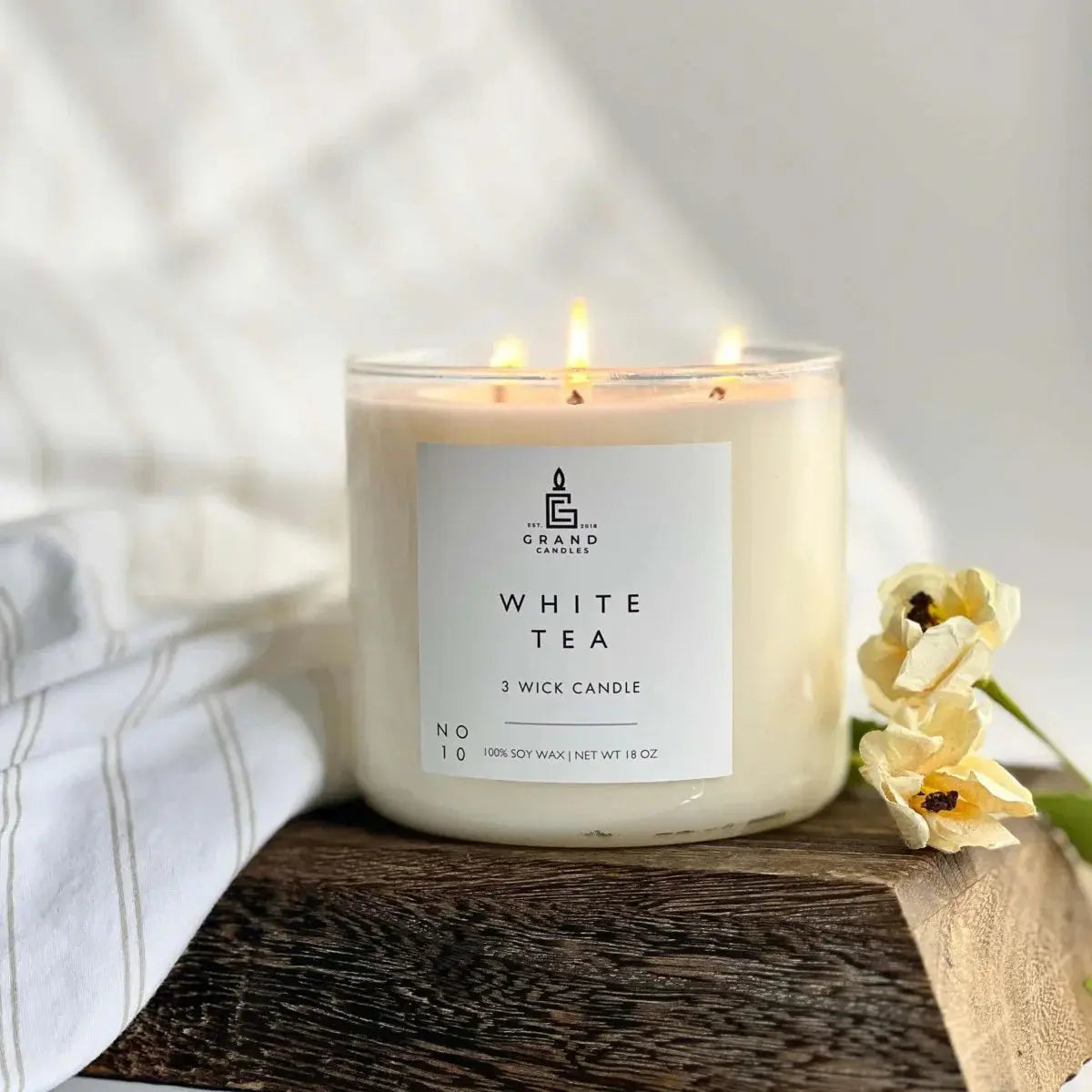 White Tea 3-wick soy candle on rustic wood with soft linen, cozy farmhouse decor