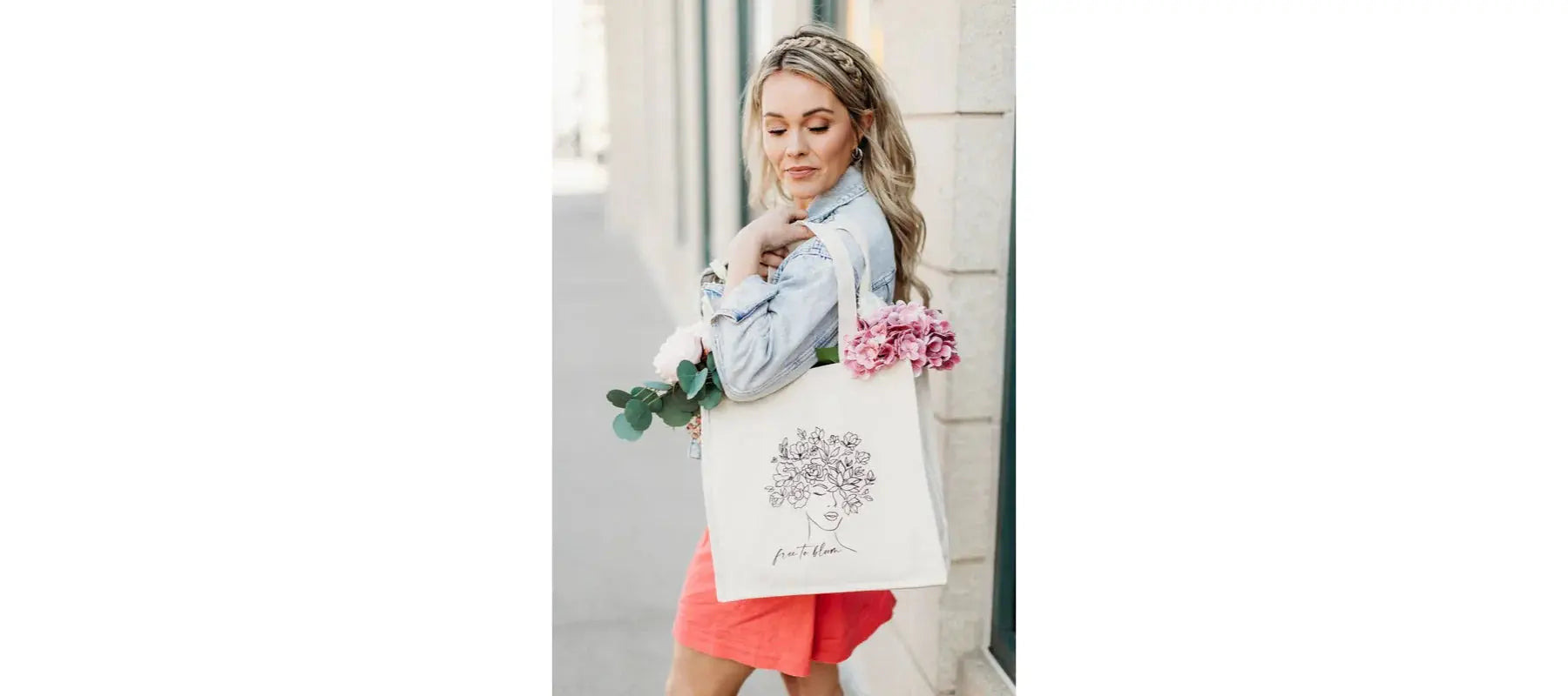 Woman carrying floral tote bag with 'free to bloom' design, perfect for cozy cottage style gifts