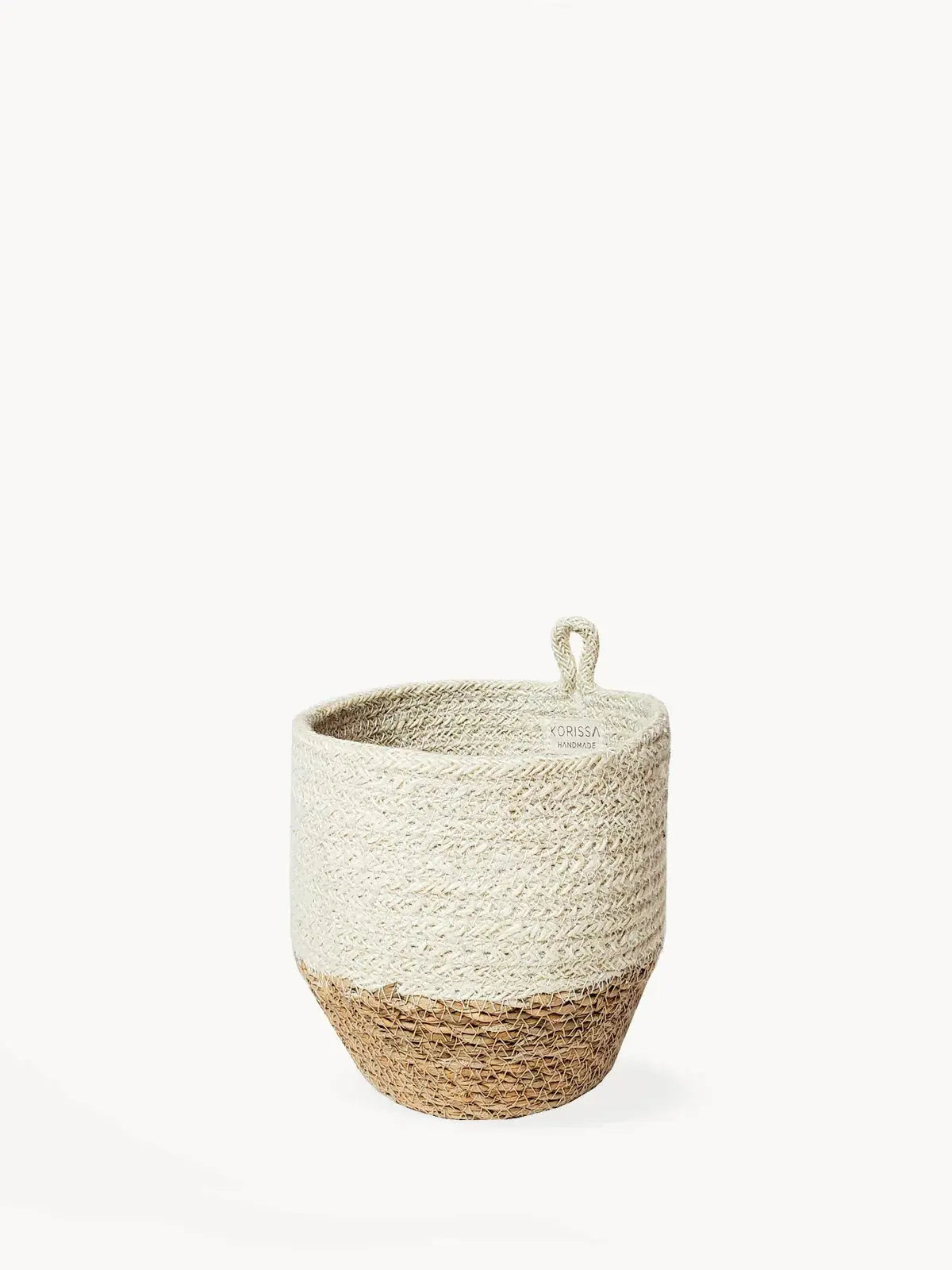 Handwoven farmhouse storage basket with natural and cream tones, perfect for cozy cottage decor