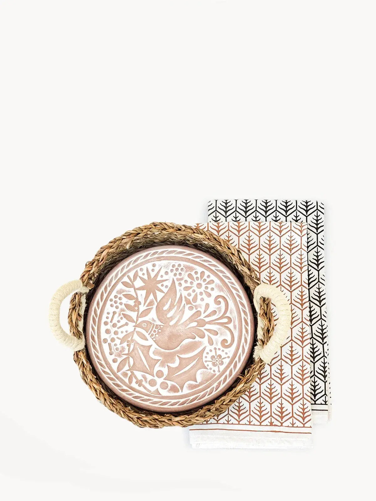Woven tray with ceramic bird plate and patterned napkins, farmhouse kitchen decor
