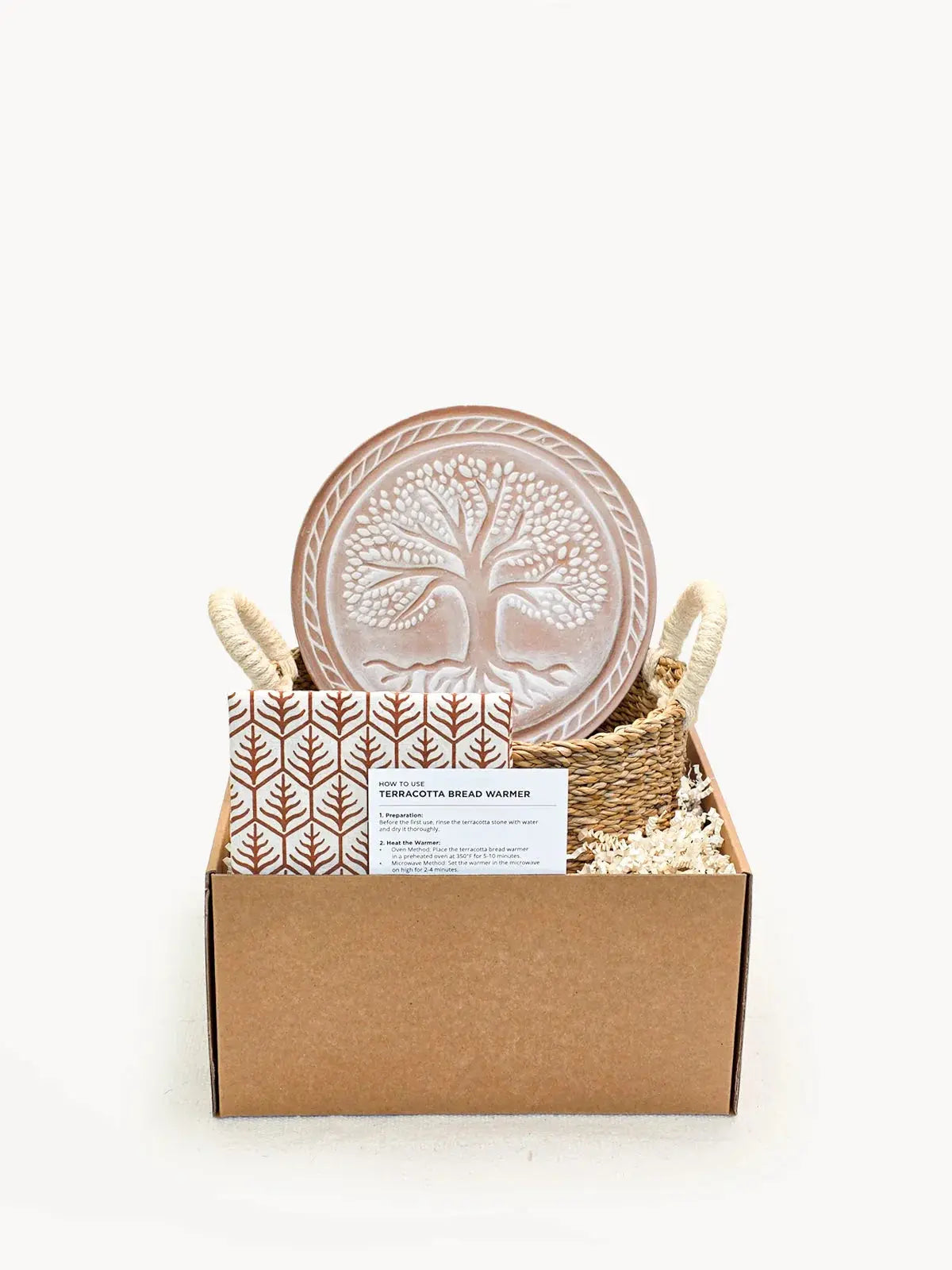 Terracotta bread warmer with tree design in woven basket, cozy farmhouse kitchen decor gift set