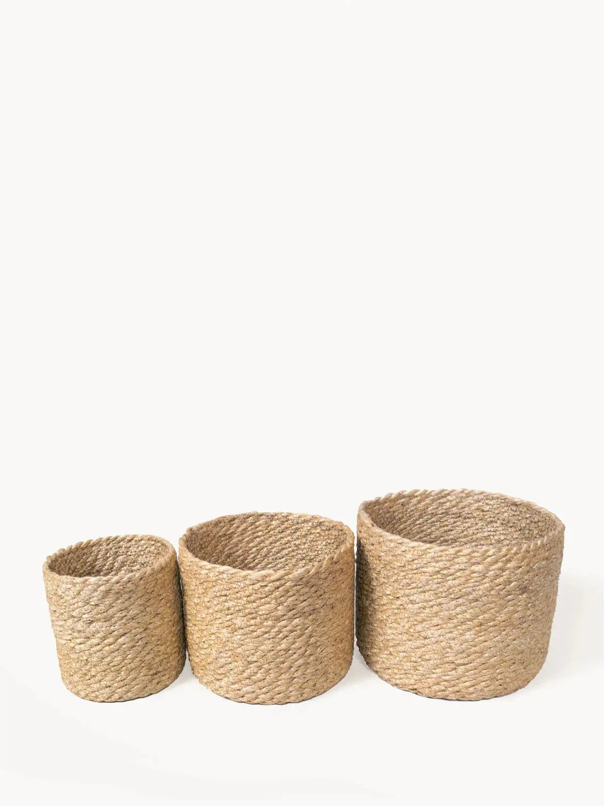 Set of three natural woven seagrass baskets for farmhouse or cottage style home decor storage