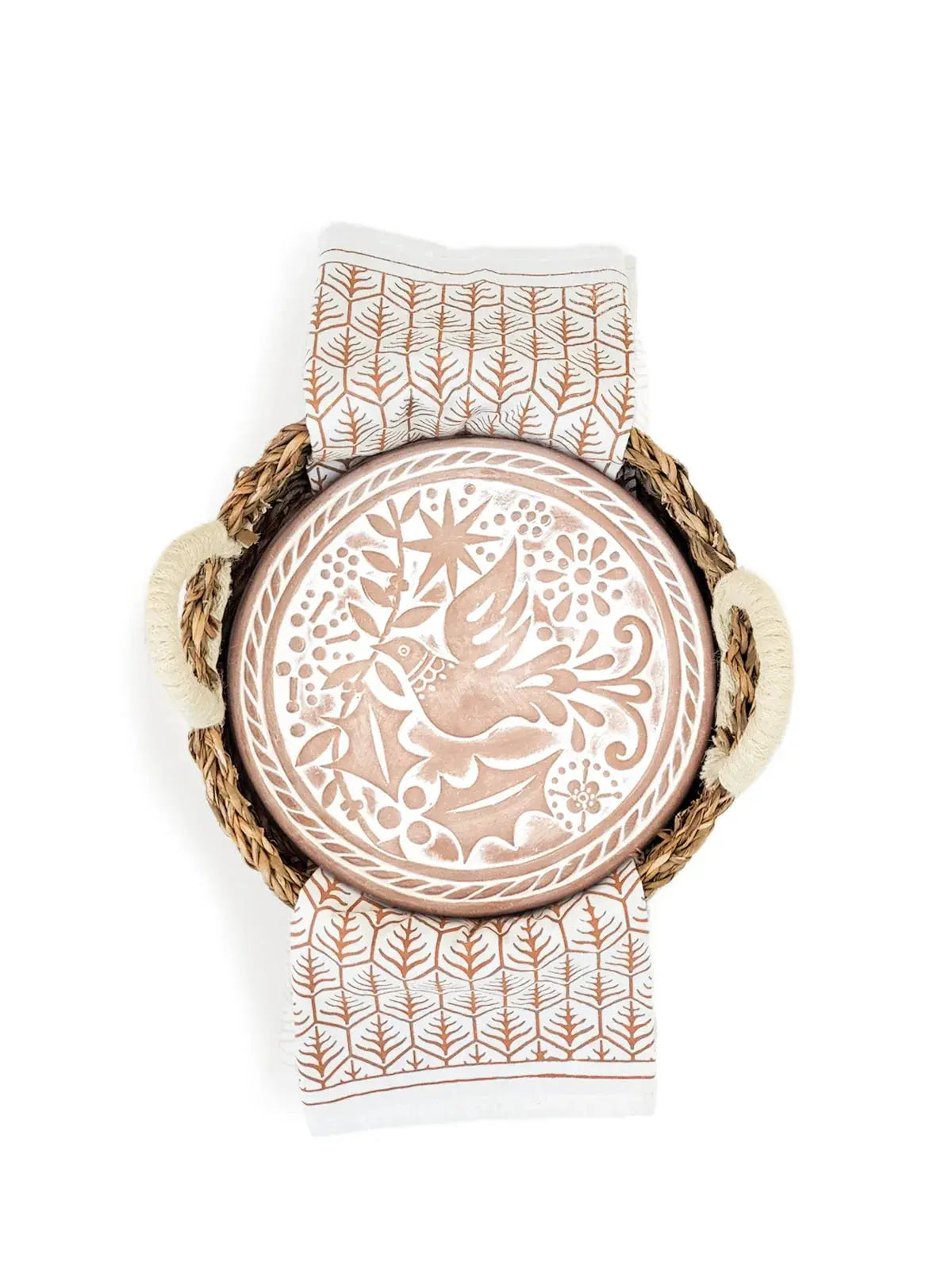 Farmhouse ceramic plate with bird design in woven basket, paired with leaf-patterned napkins for cozy home decor