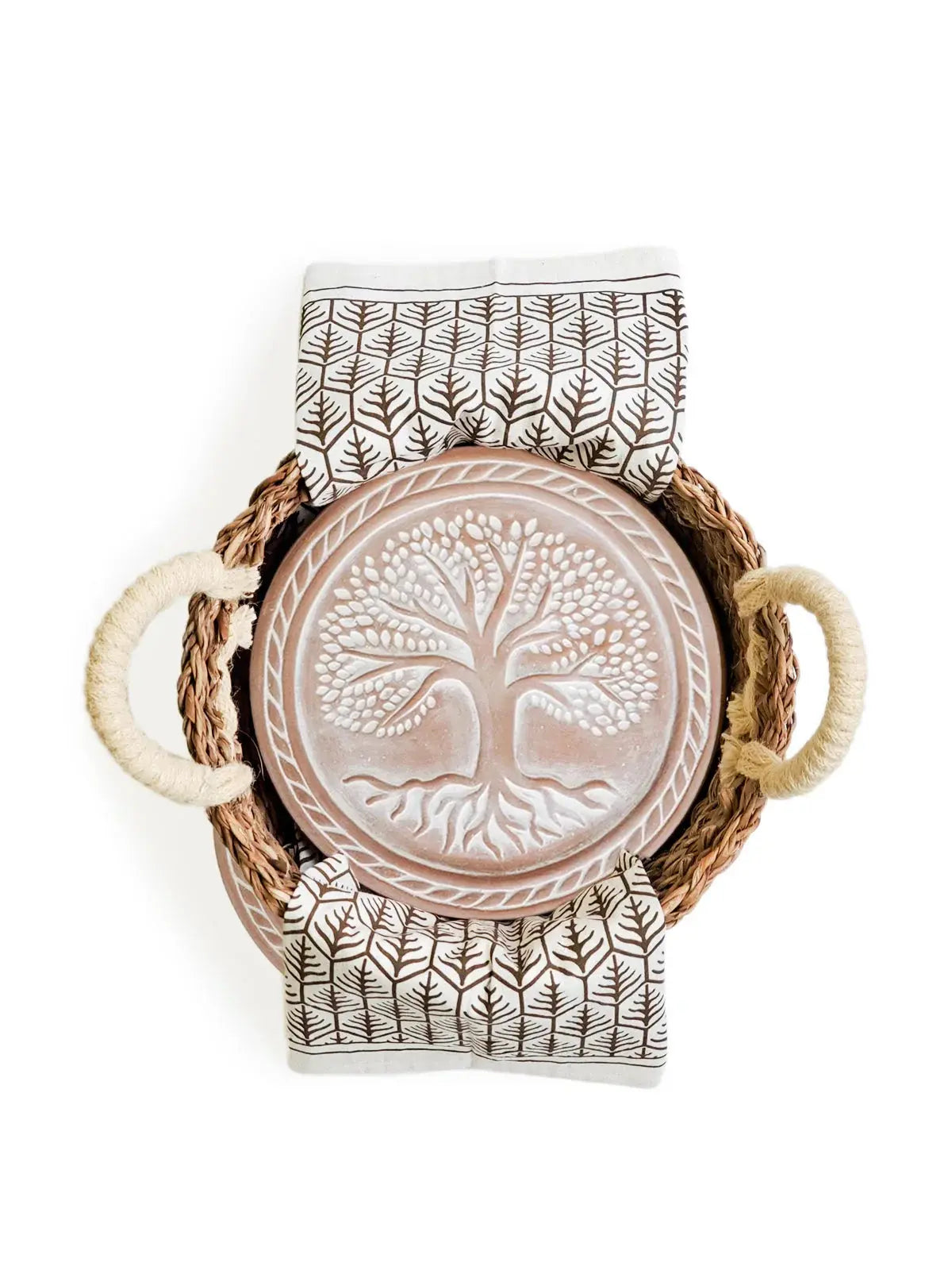 Woven basket with tree of life ceramic plate and leaf-patterned napkins, farmhouse home decor