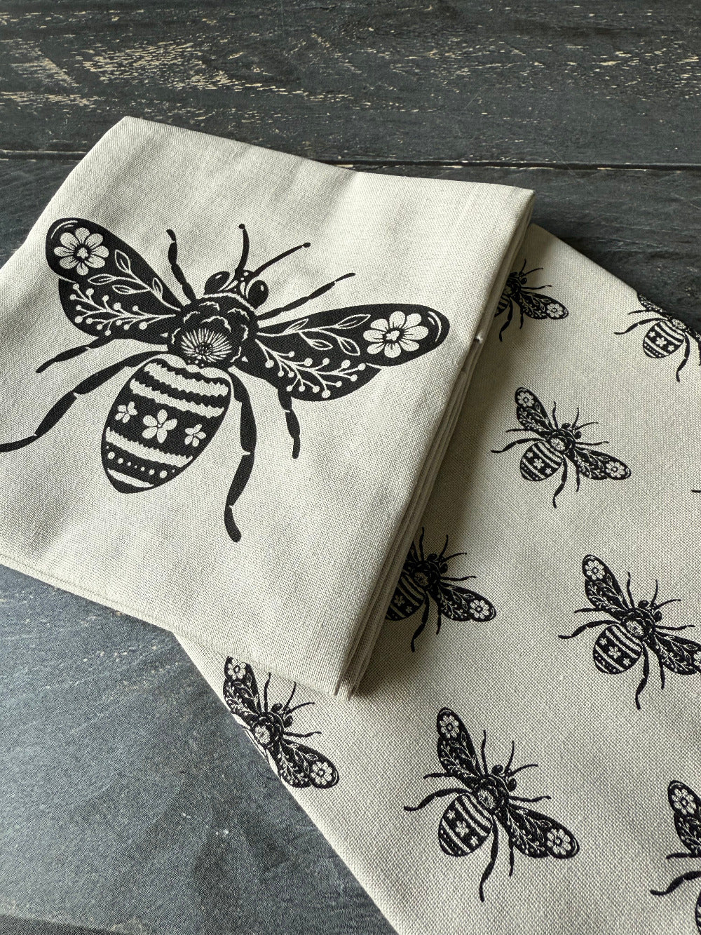 Napkin with bee design on a wooden surface