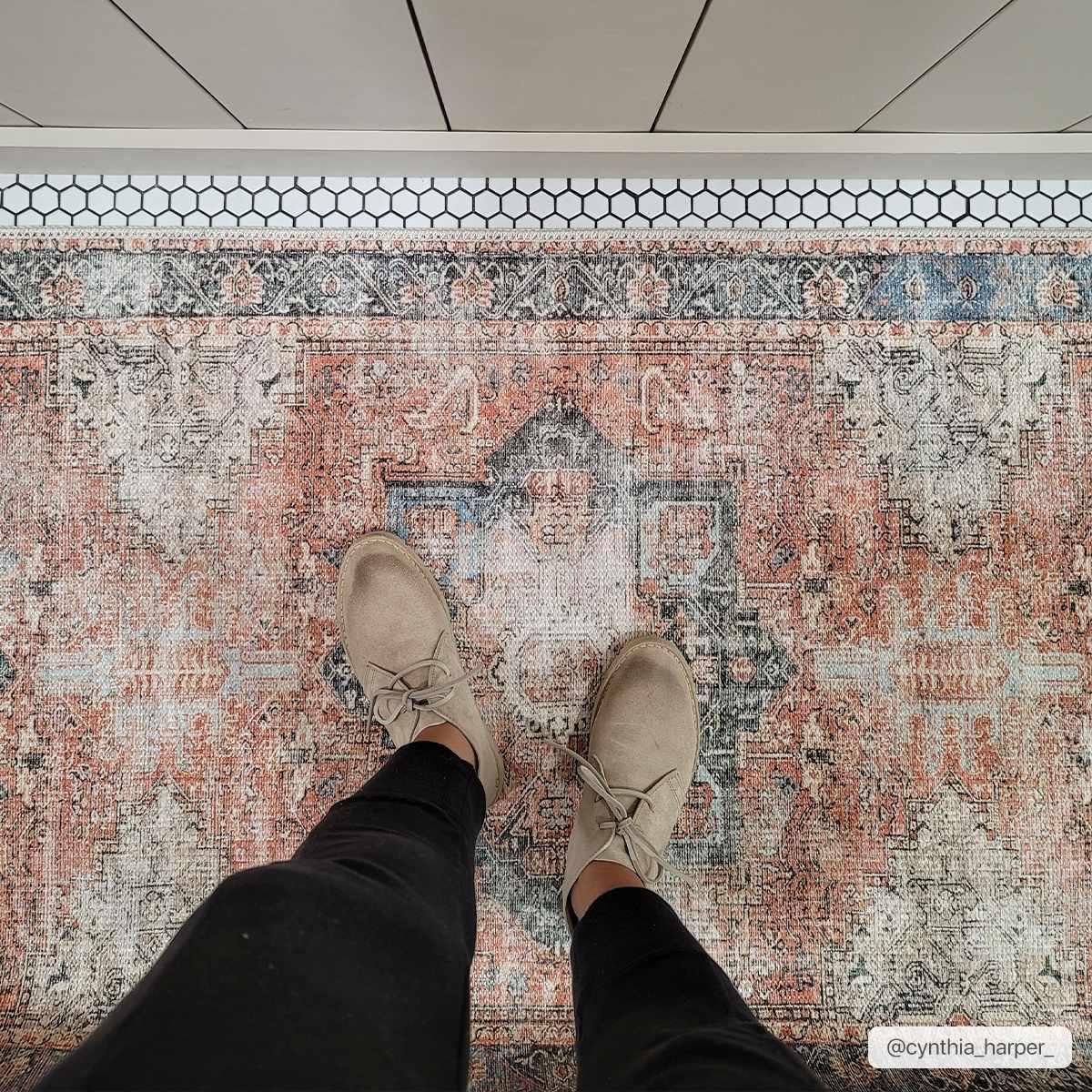 Vintage-style area rug with boho pattern, perfect for farmhouse or cottage decor, paired with neutral shoes.