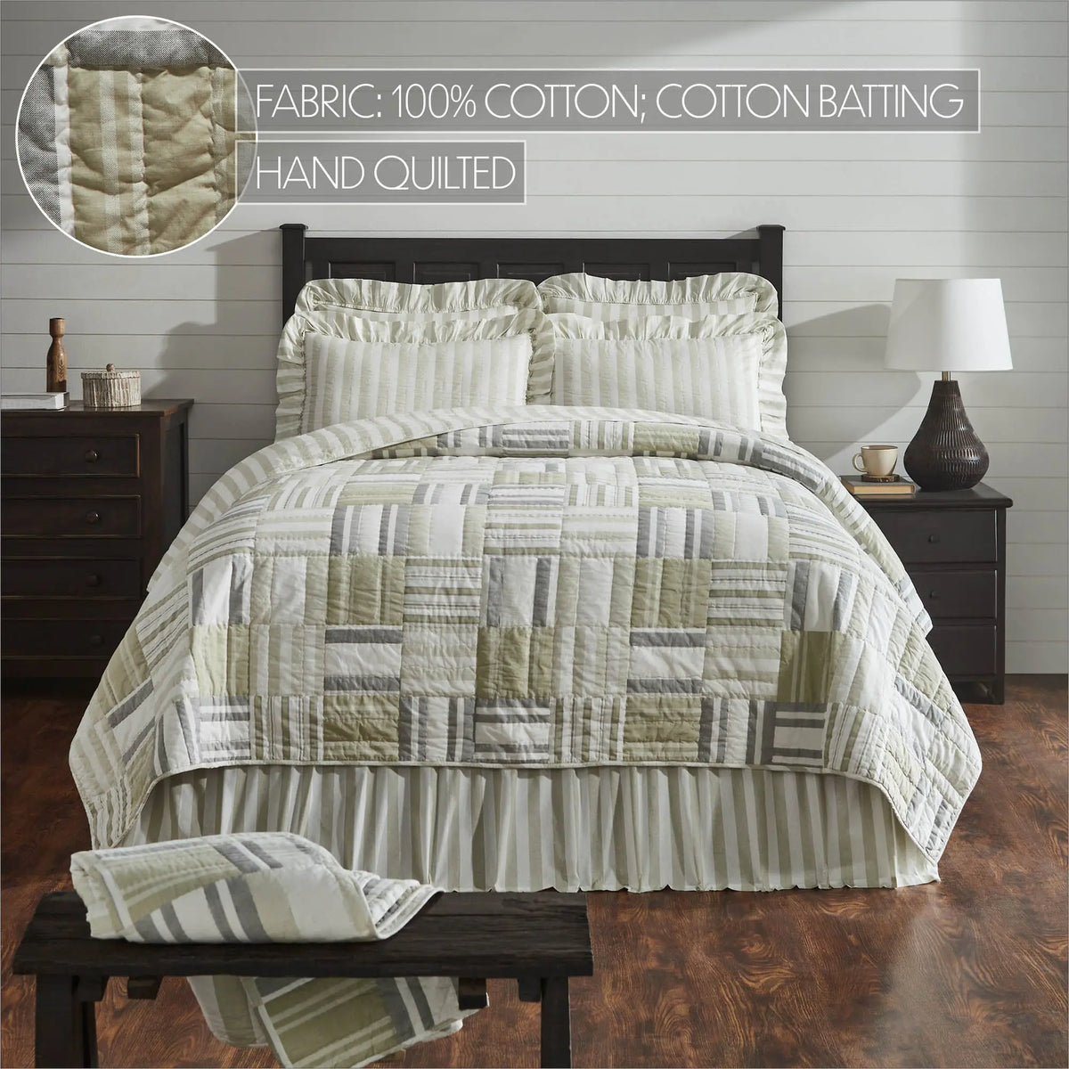 A quilted bedding set displayed on a bed in a styled bedroom. The set includes a patchwork quilt in cream, beige, sage green, and gray, matching striped pillow shams, and a ruffled bed skirt.