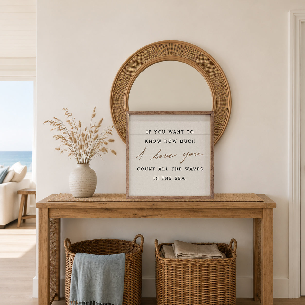 Nautical-themed room with wooden console table, round mirror, and motivational quote sign.
