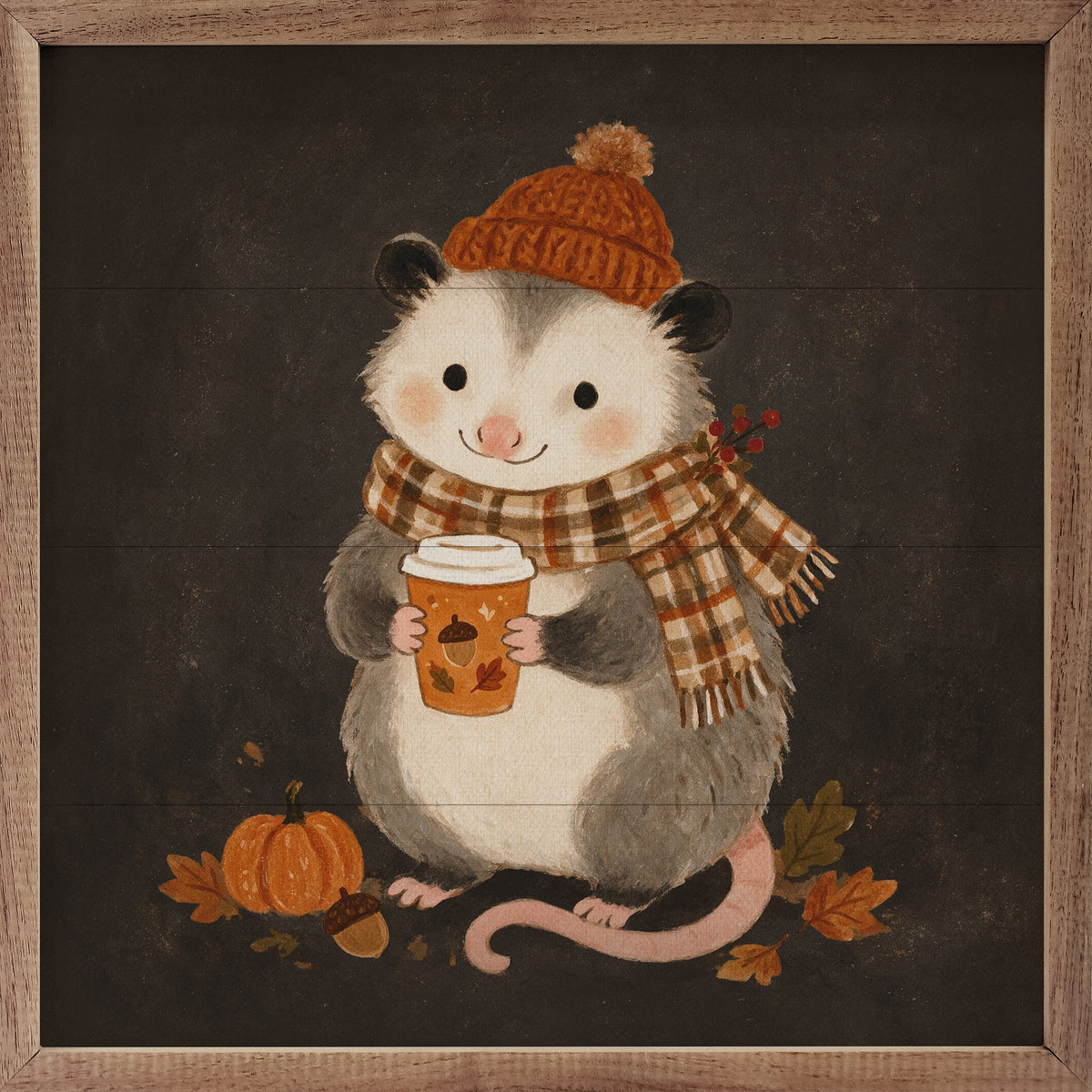 A square framed art print featuring a cute cartoon possum wearing an orange knit hat and a brown-and-cream plaid scarf, holding an orange coffee cup. The scene includes a small pumpkin, acorn, and autumn leaves on a dark background, surrounded by a rustic wood frame.