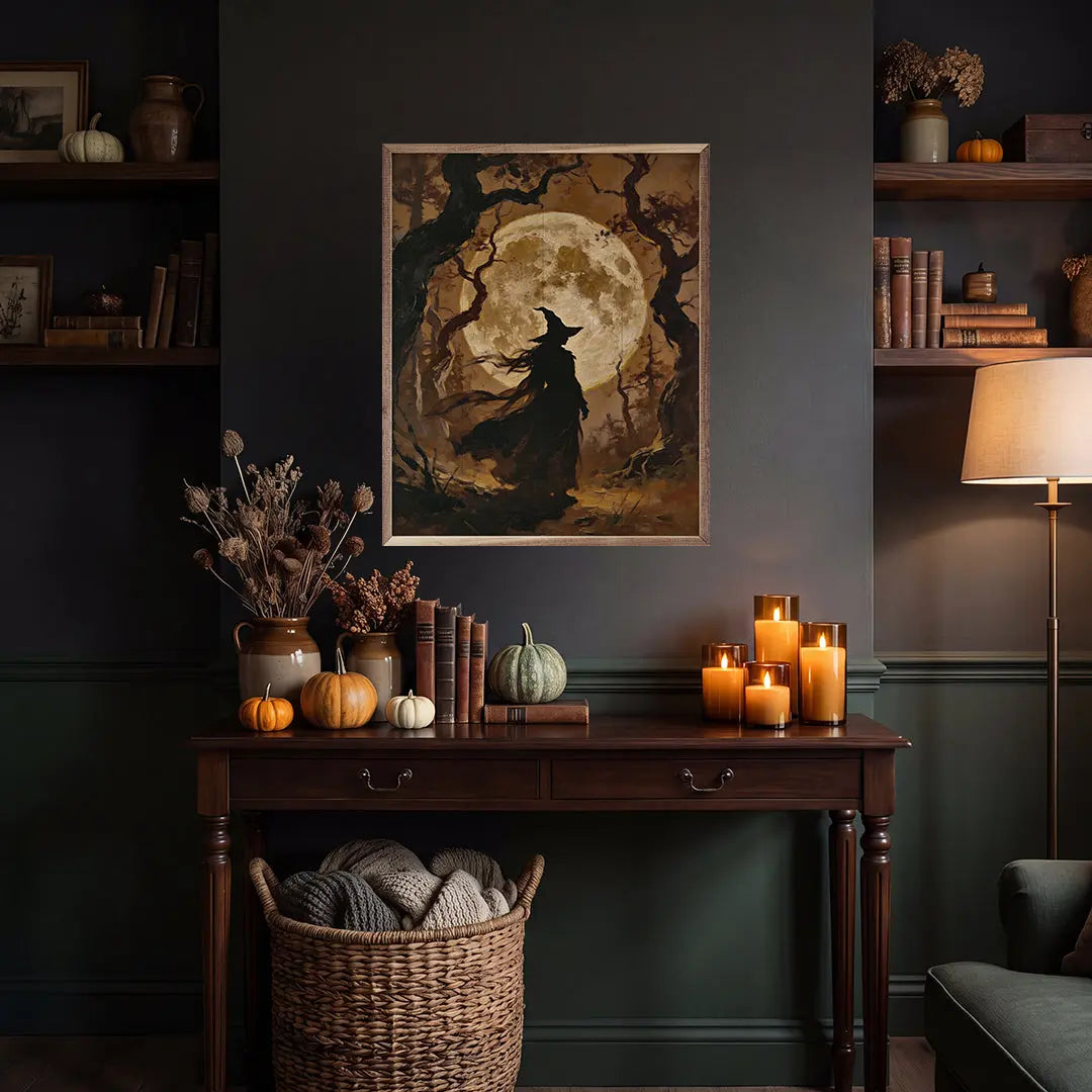 Halloween-themed room with a witch silhouette painting, candles, and pumpkins on a wooden table.