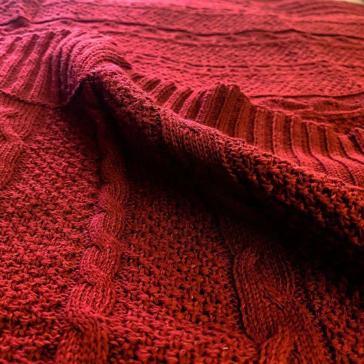 Cozy red knitted blanket with cable knit pattern for farmhouse cottage decor