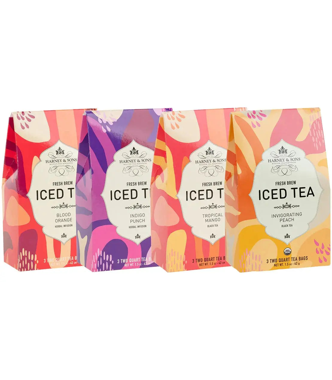 Four colorful Harney & Sons iced tea boxes: Blood Orange, Indigo Punch, Tropical Mango, Invigorating Peach