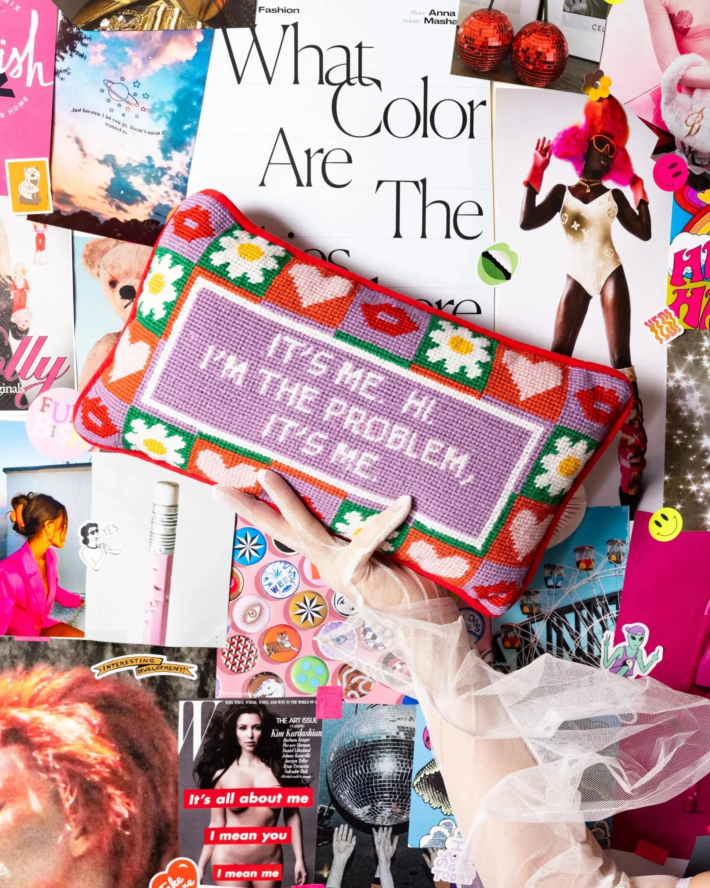 Colorful pouch with text held over a collage of magazine clippings.