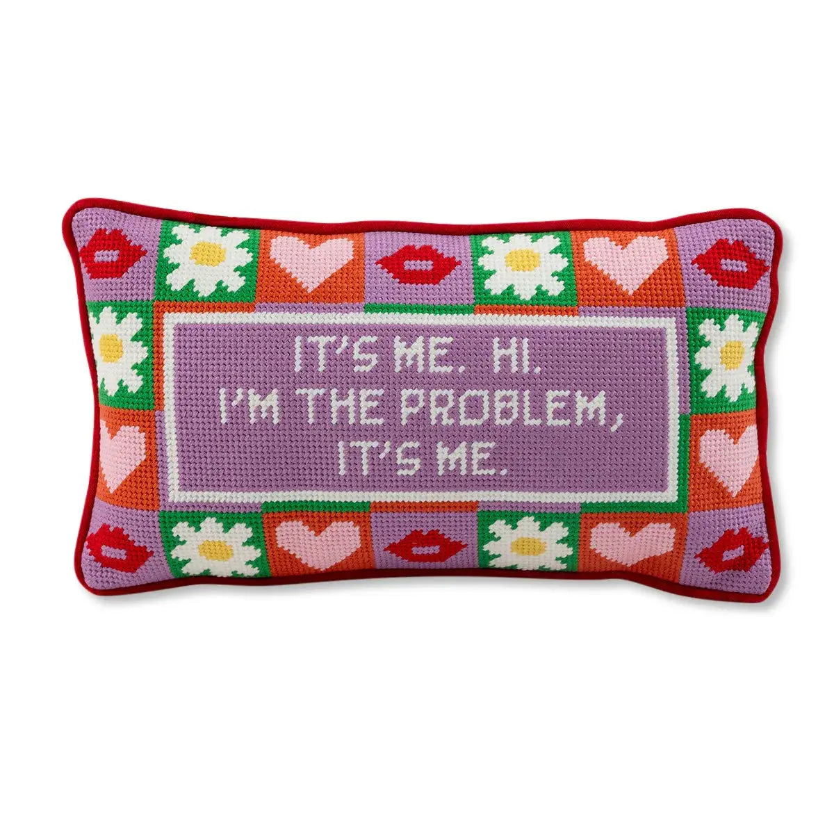 Decorative pillow with colorful border, hearts, flowers, and text on a white background