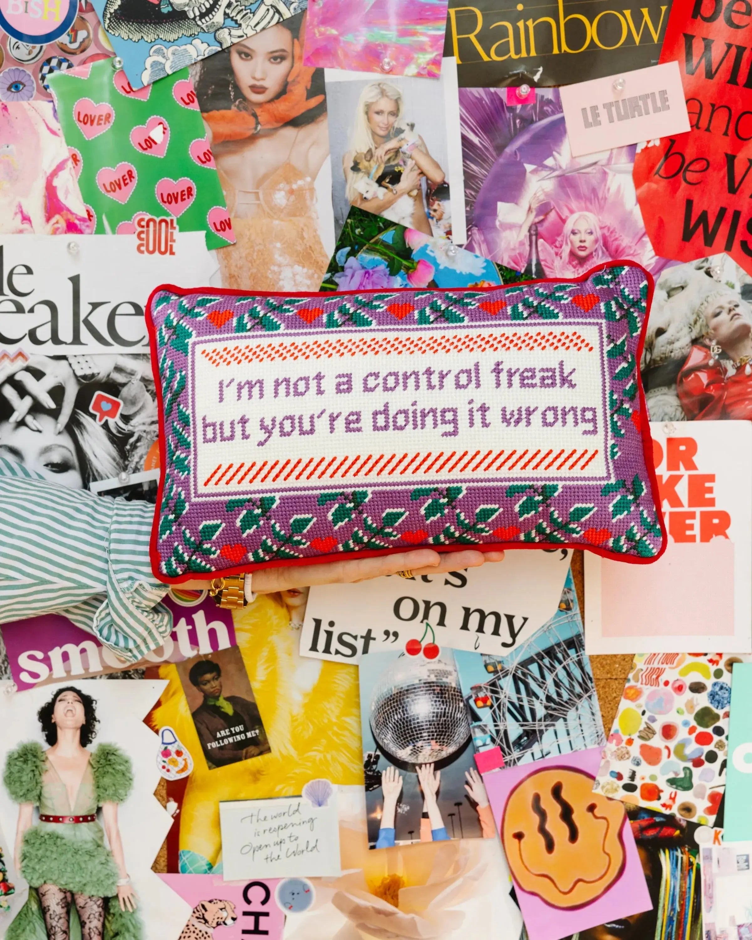 Cross-stitch pillow with funny quote 'I'm not a control freak but you're doing it wrong' on colorful collage background