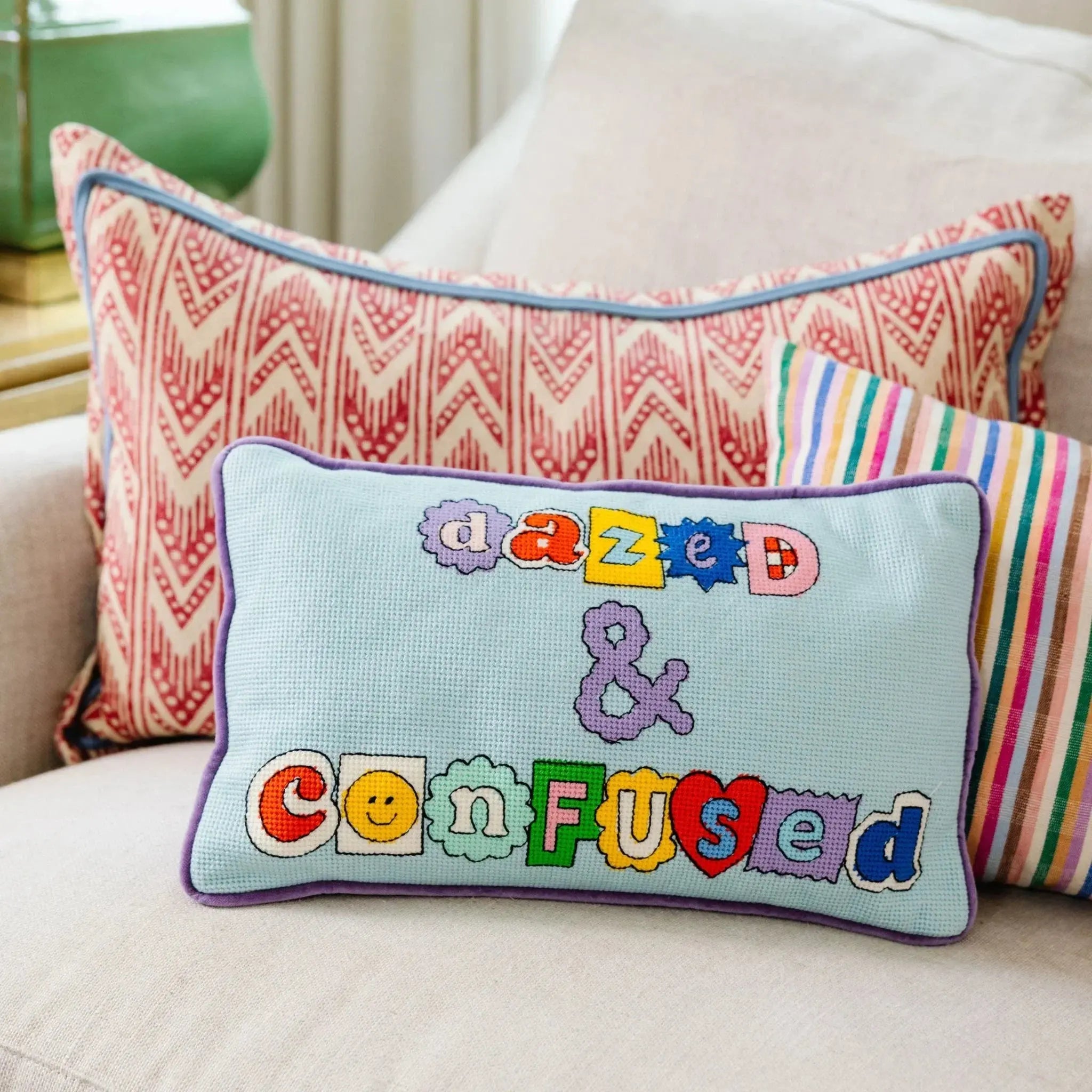 Decorative pillow with 'dazed & confused' text on a couch