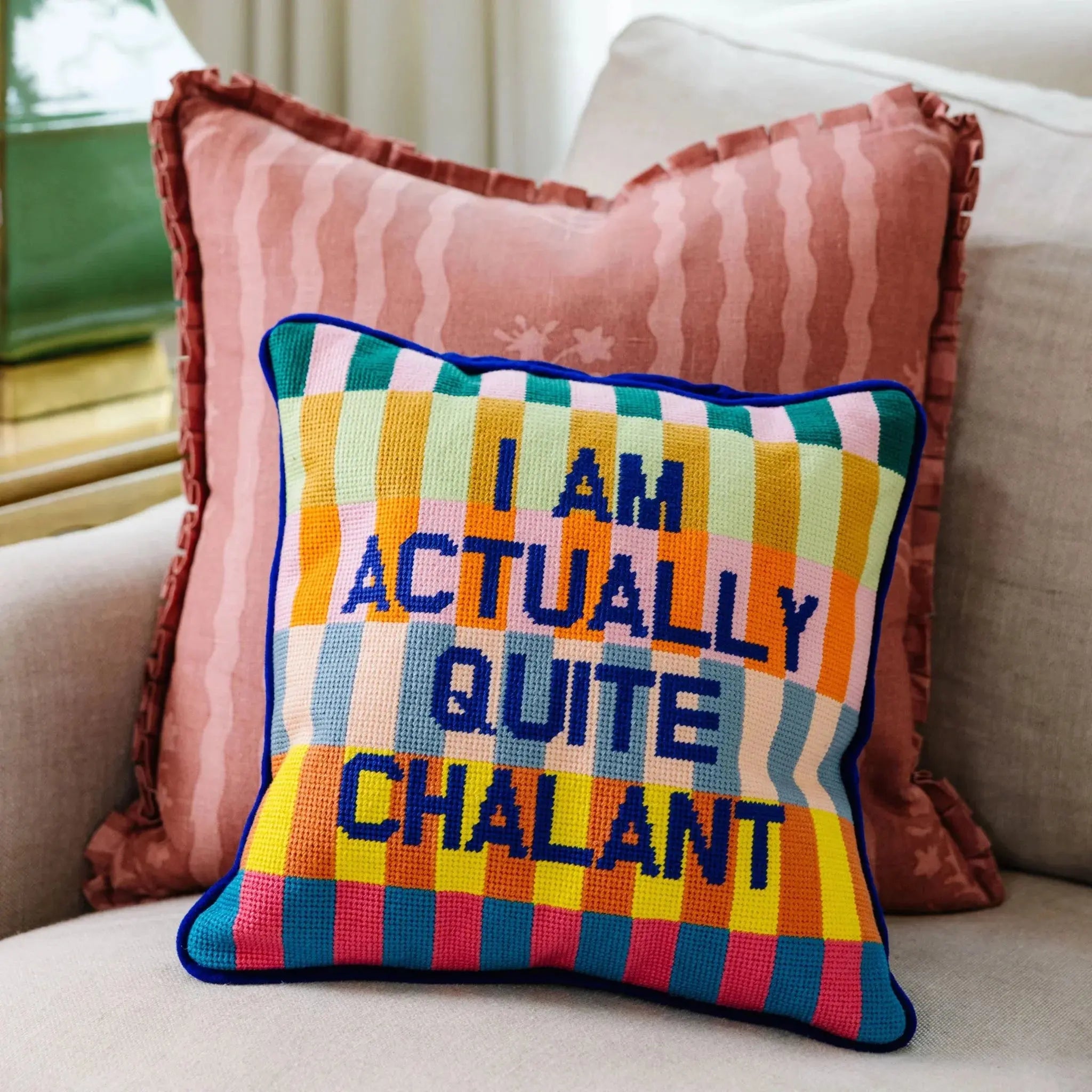 Colorful striped pillow with 'I AM ACTUALLY QUITE CHALANT' text, cozy farmhouse decor