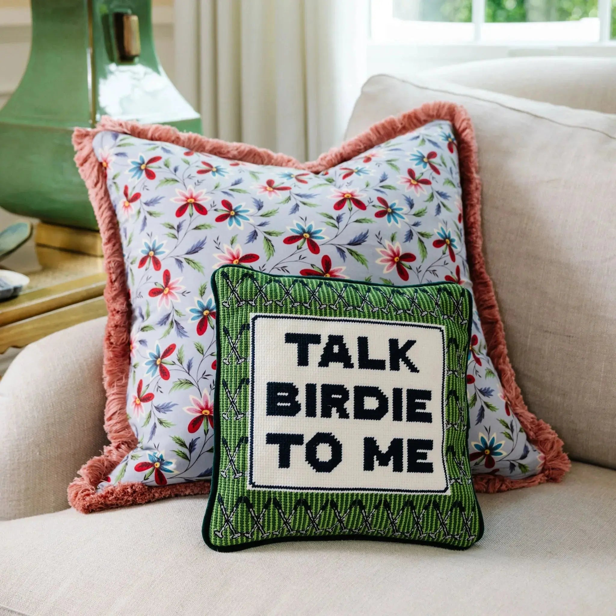 Floral and golf-themed throw pillows with fringe, cozy farmhouse decor for living room
