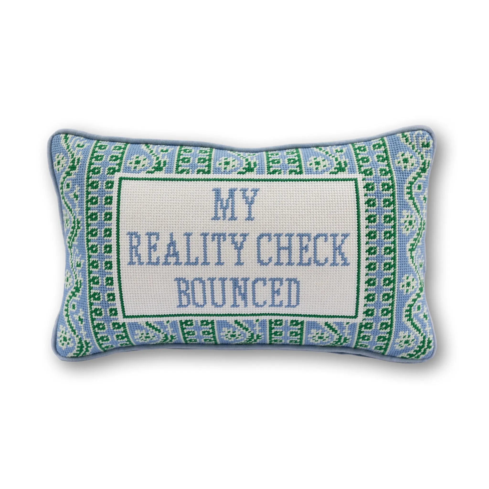 Decorative pillow with text 'My reality check bounced' on a white background