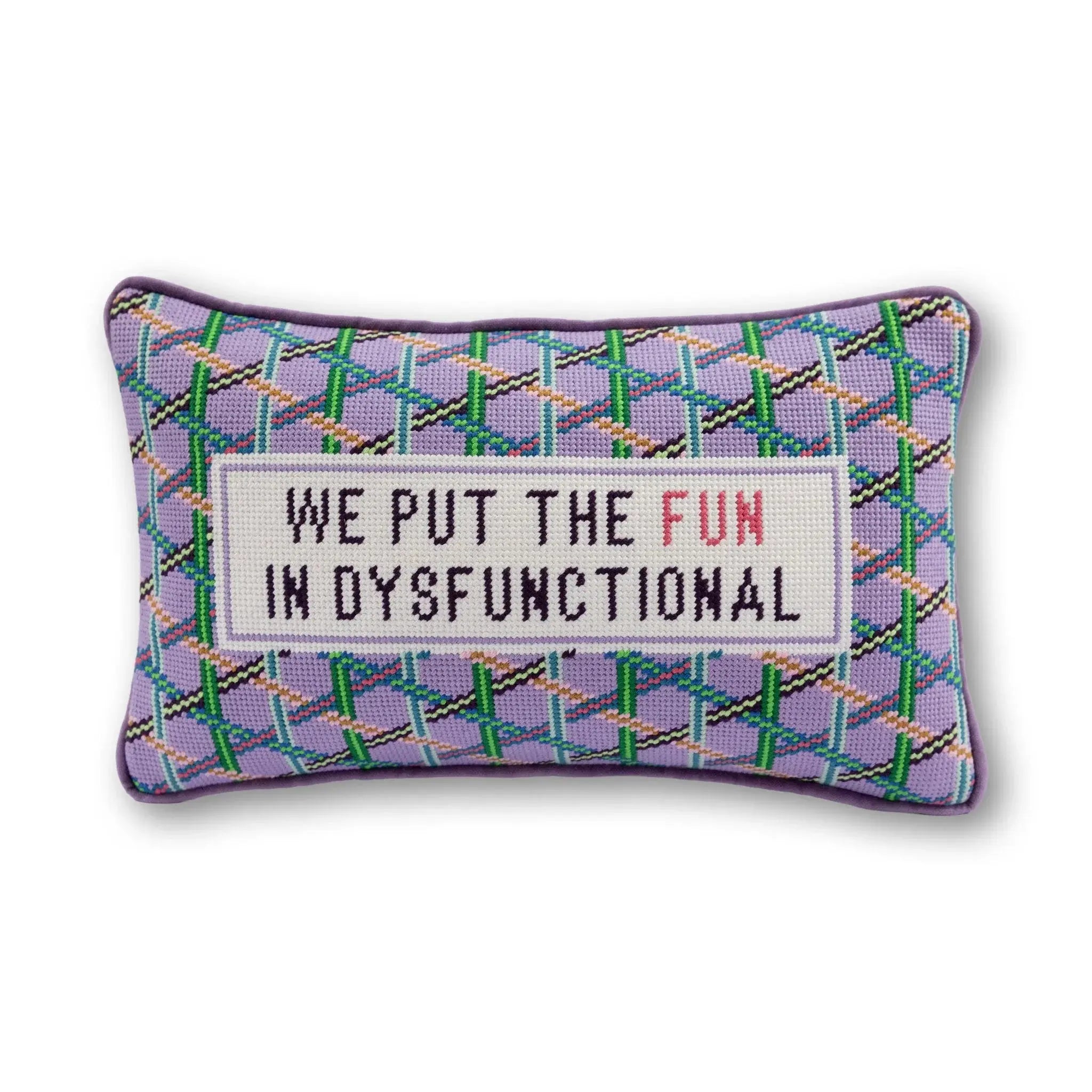Decorative pillow with text 'We put the fun in dysfunctional' on a white background