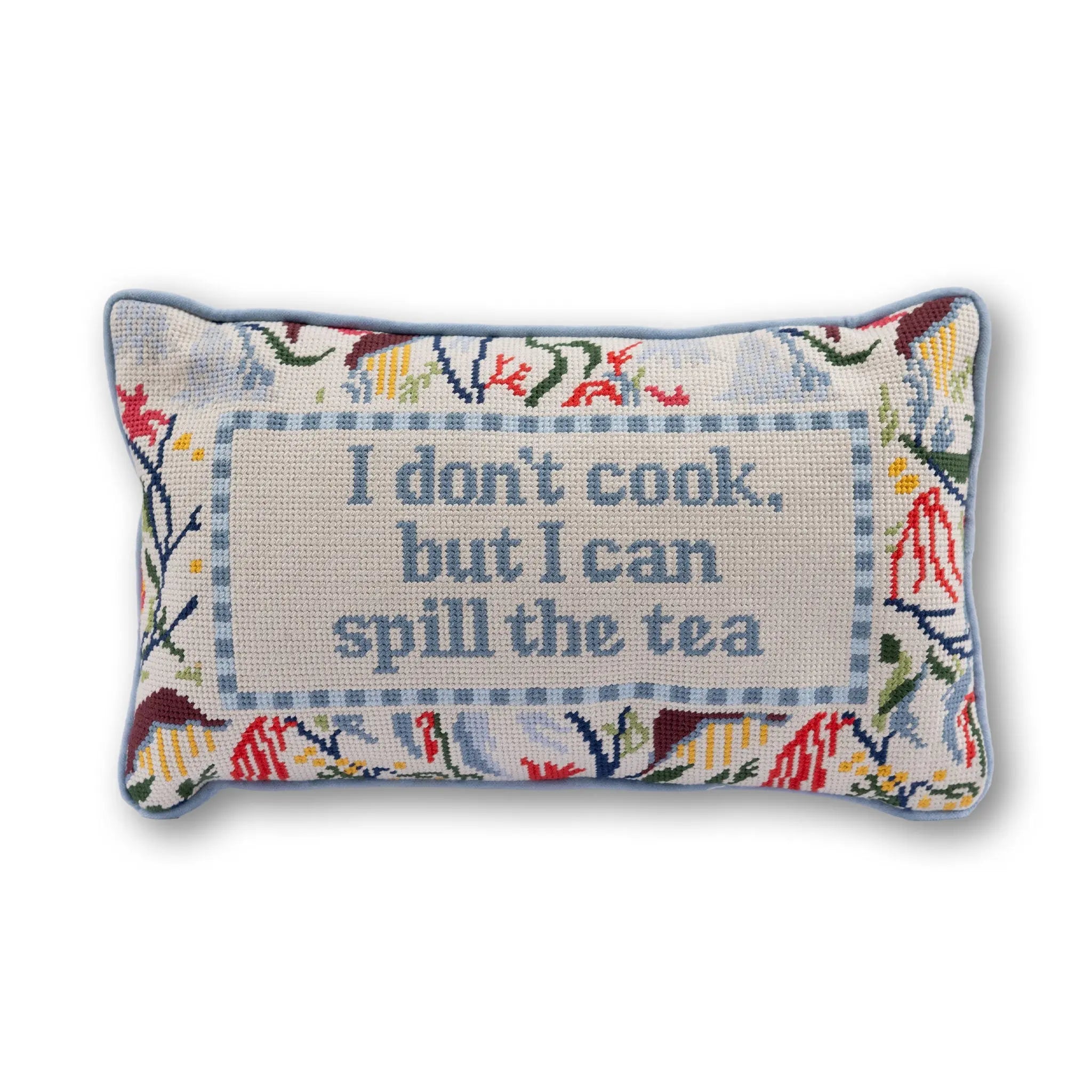 Decorative pillow with floral border and text 'I don't cook, but I can spill the tea' on a white background