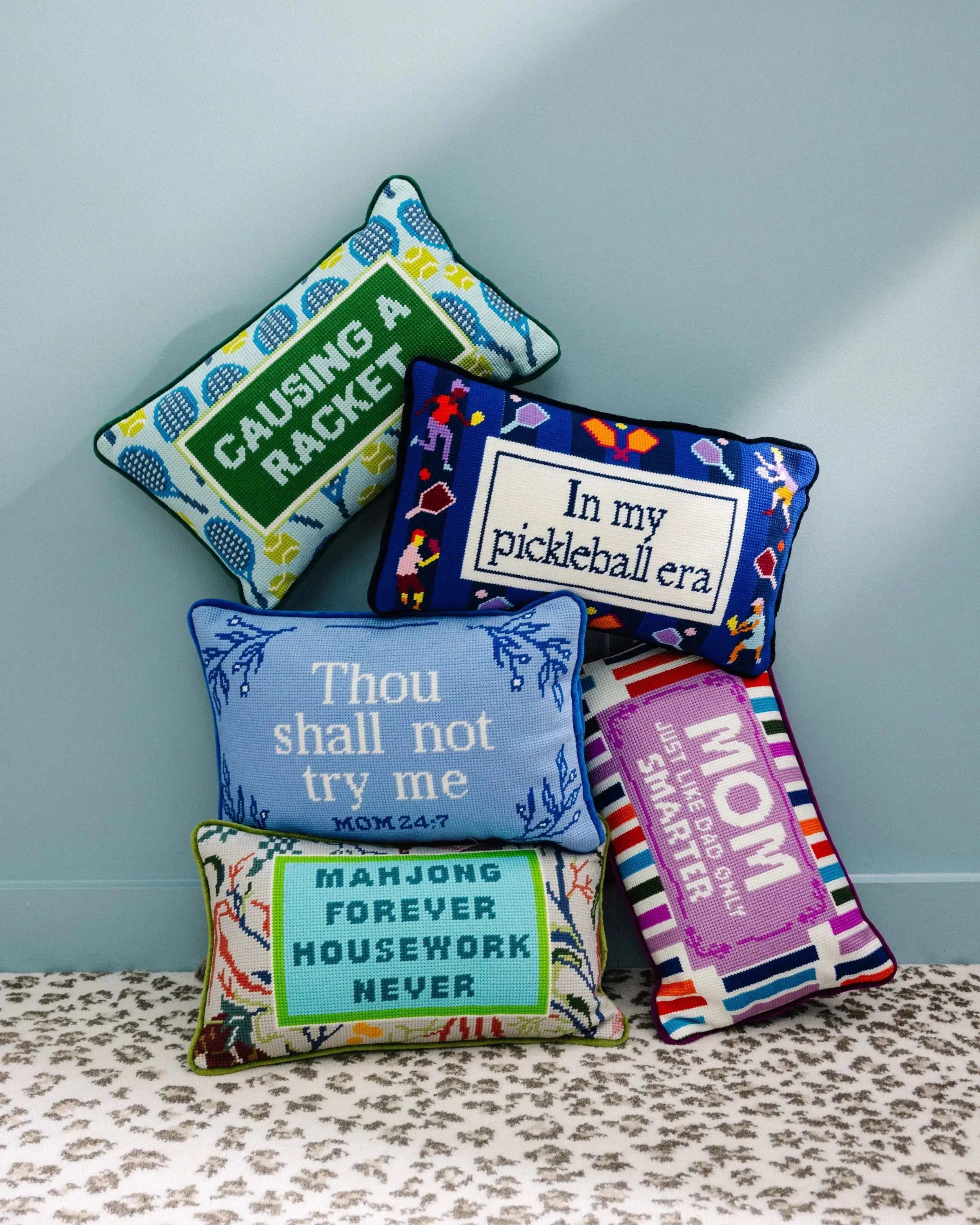 Colorful embroidered pillows with playful phrases for cozy farmhouse decor