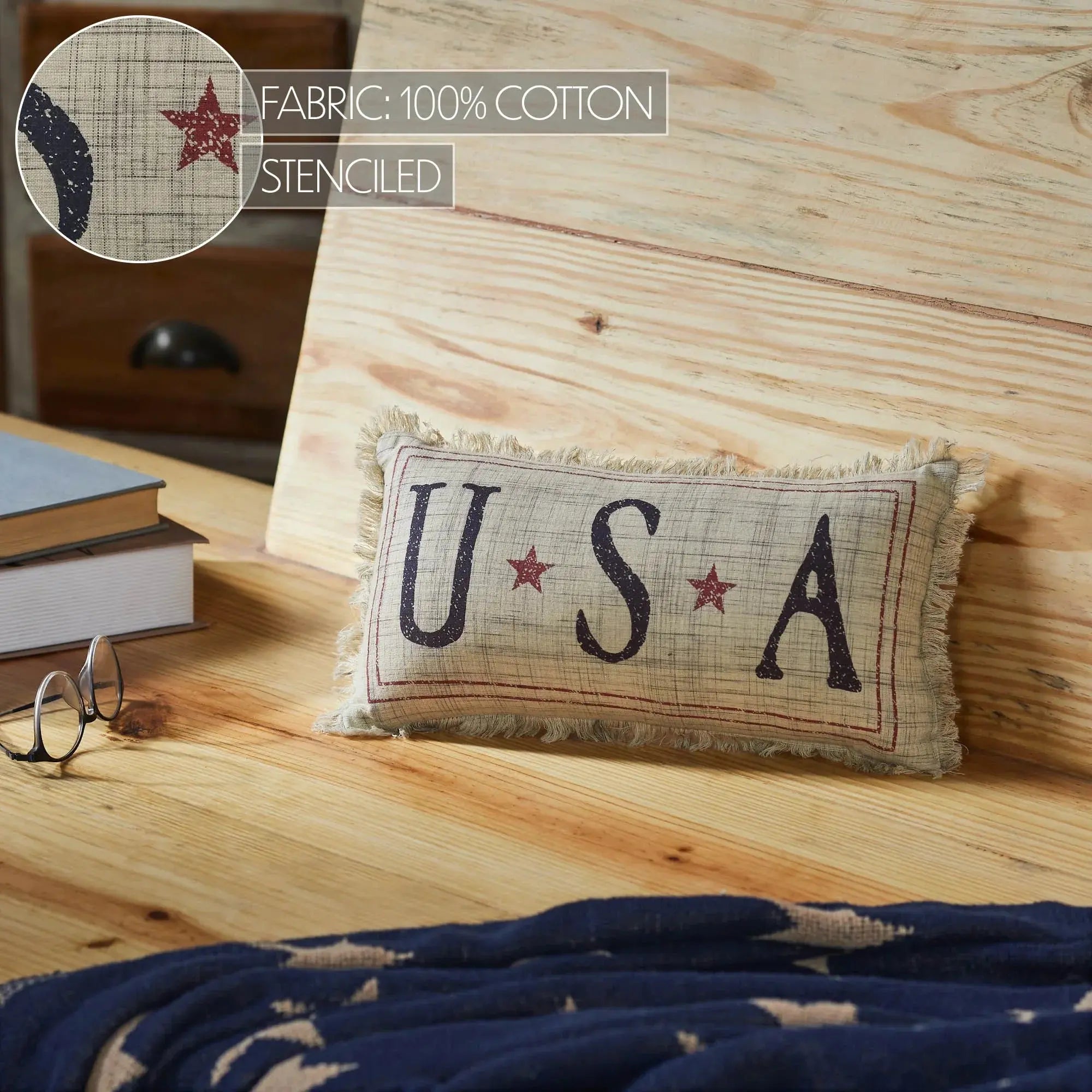 USA stenciled cotton pillow with stars, farmhouse decor on wooden surface