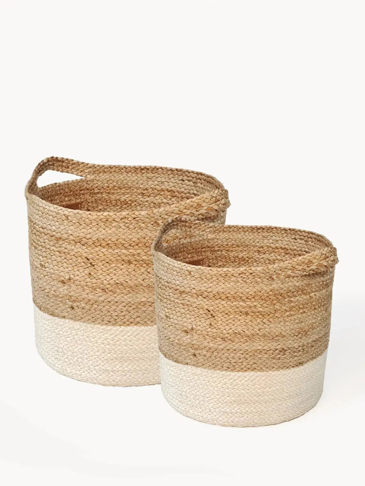 Set of two woven jute baskets with cream dip-dye base, perfect for farmhouse or cottage style home decor storage.