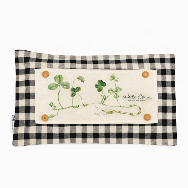 A rectangular fabric pouch or case with a black and beige gingham border and a central cream patch featuring green clover illustrations and the words 'White Clover'.