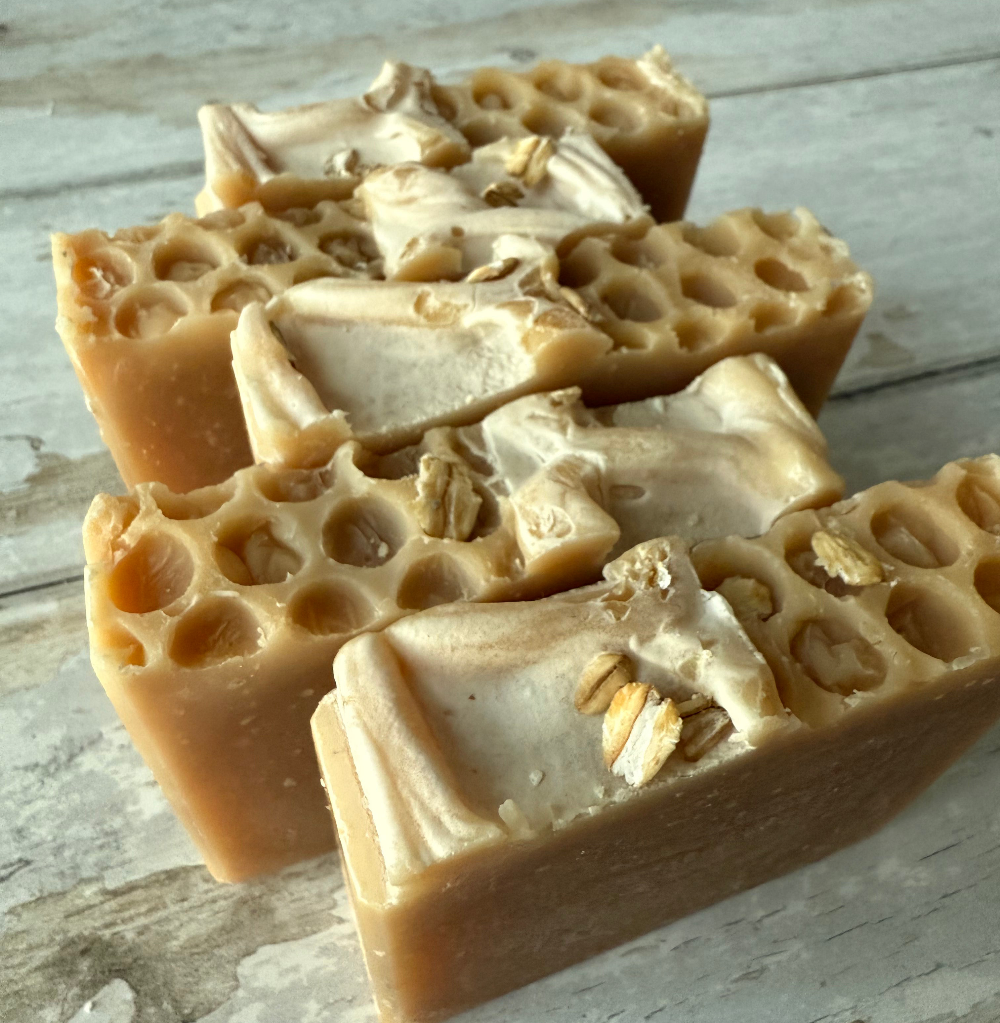 Three bars of honeycomb-textured soap on a wooden surface