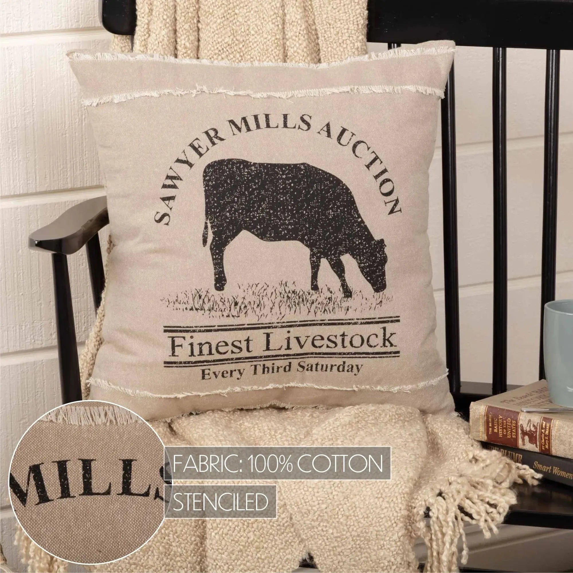Decorative pillow with cow silhouette and text on a chair