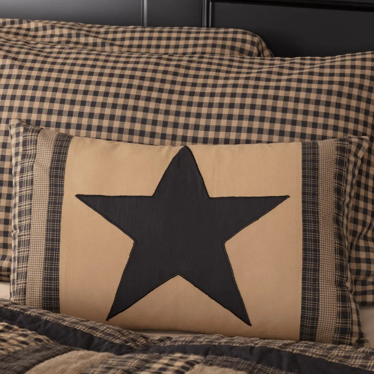 Pillow with a black star design on a checkered background
