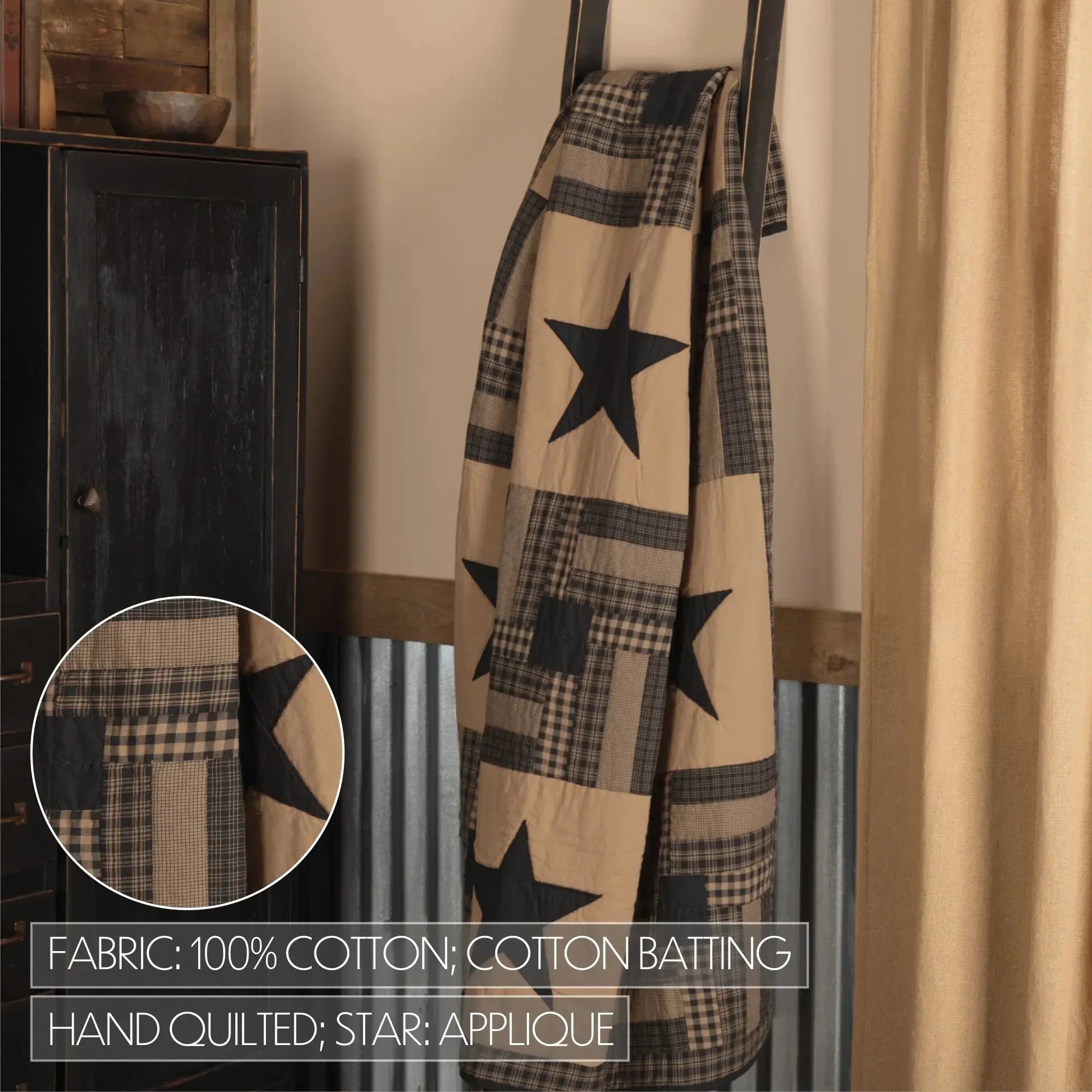 Plaid blanket with star applique hanging on a rack against a neutral wall.
