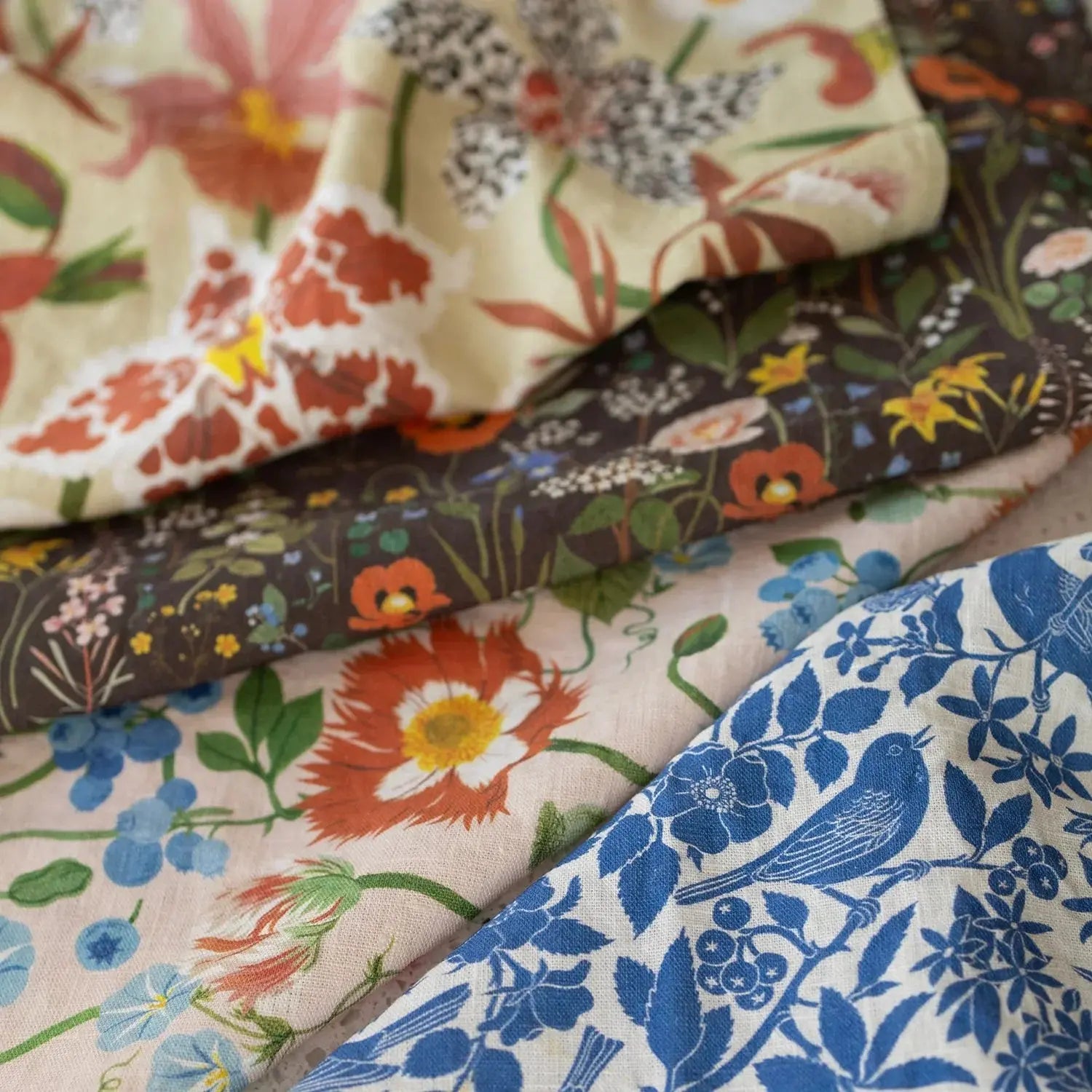Collection of floral-patterned fabrics in various colors.