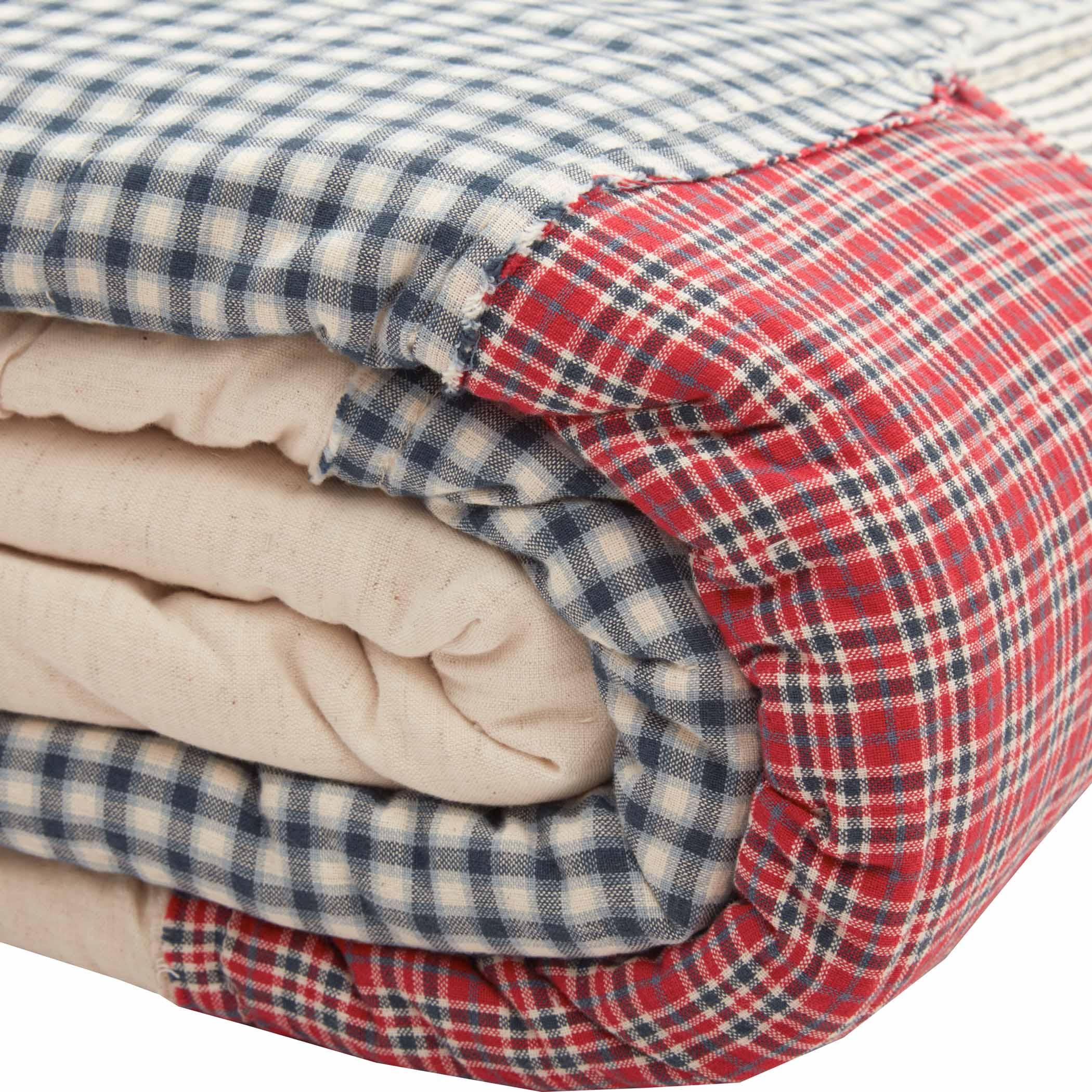 Cozy farmhouse quilt with blue gingham and red plaid patterns, perfect for cottage style home decor